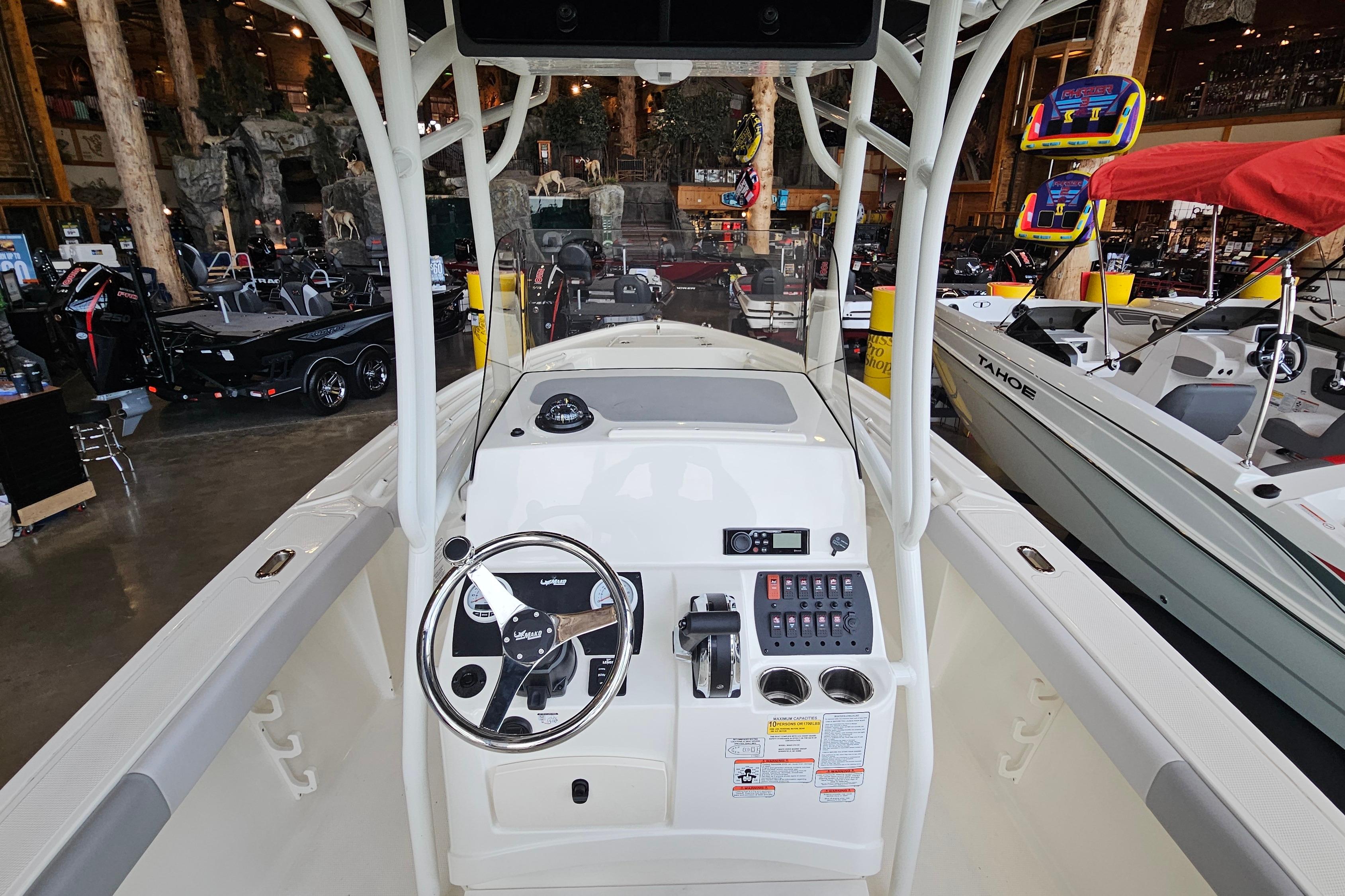 2025 Mako 214 Center Console boat interior with steering wheel and control panel.