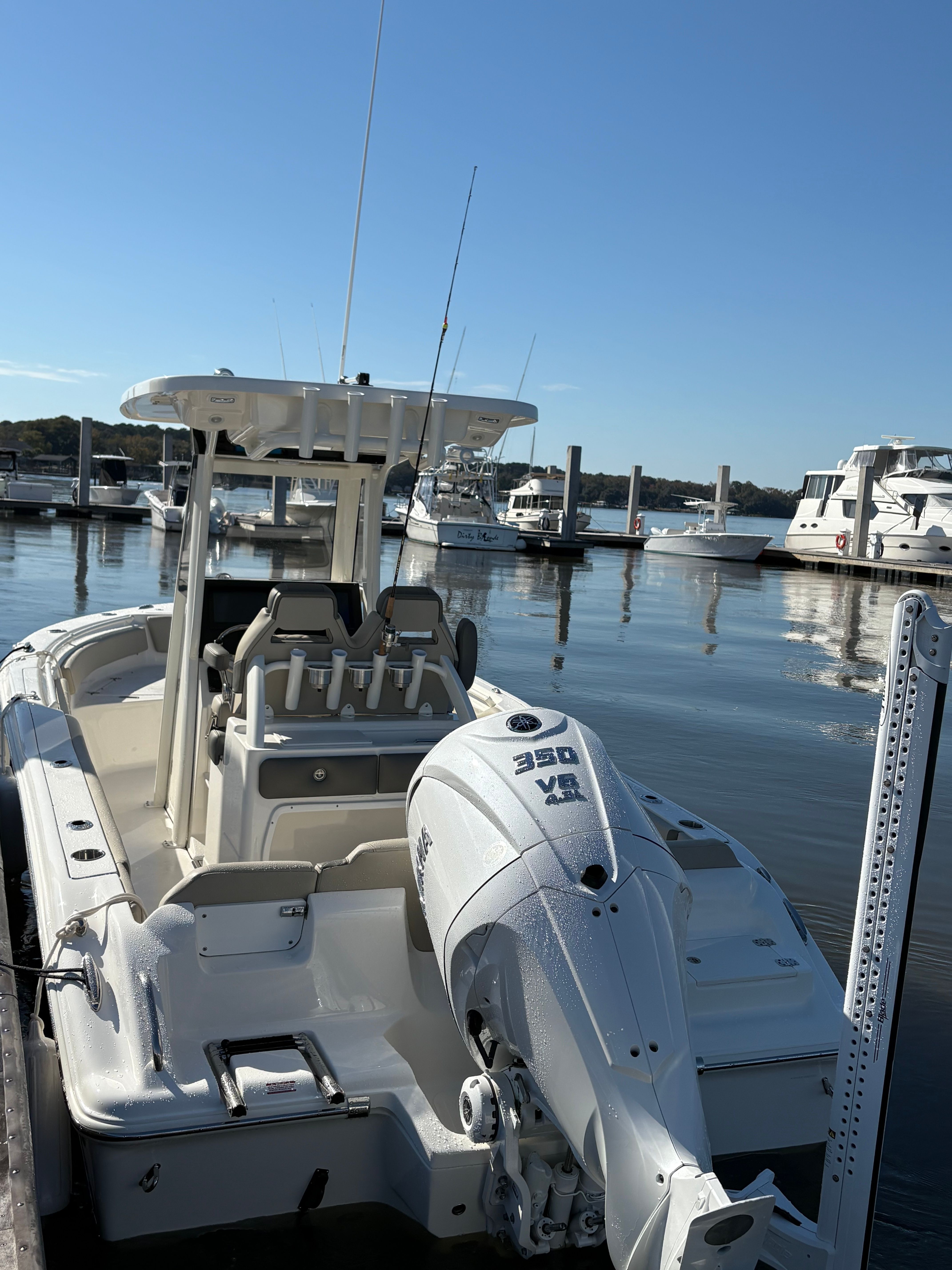 A Key West 239 FSR boat docked at a marina on a sunny day.