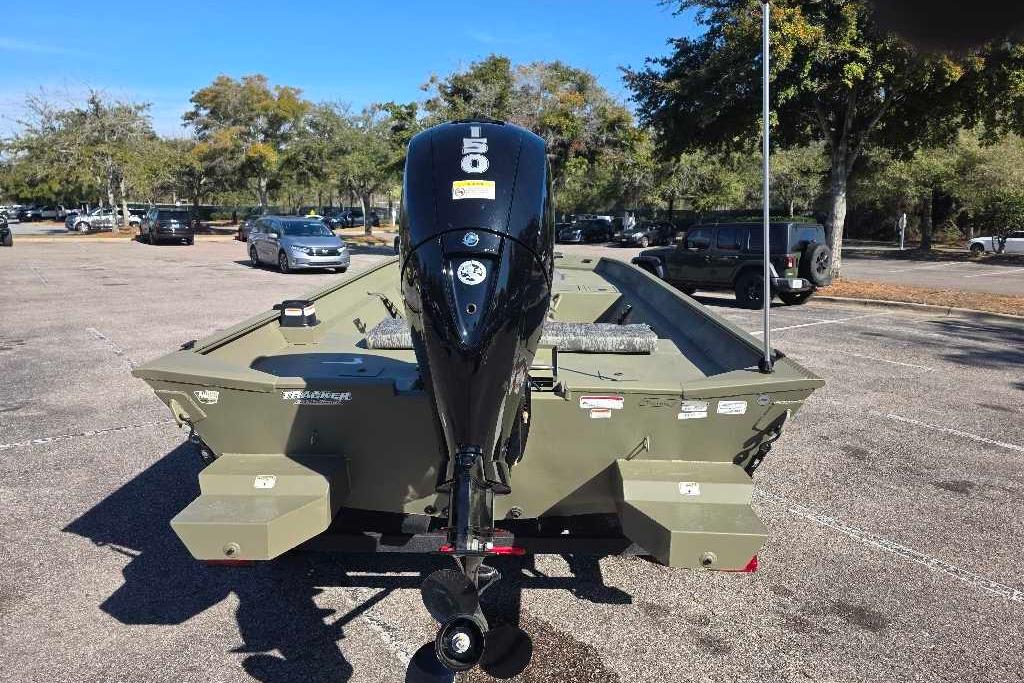 2026 Tracker Grizzly 2072 CC boat with outboard motor in a parking lot.