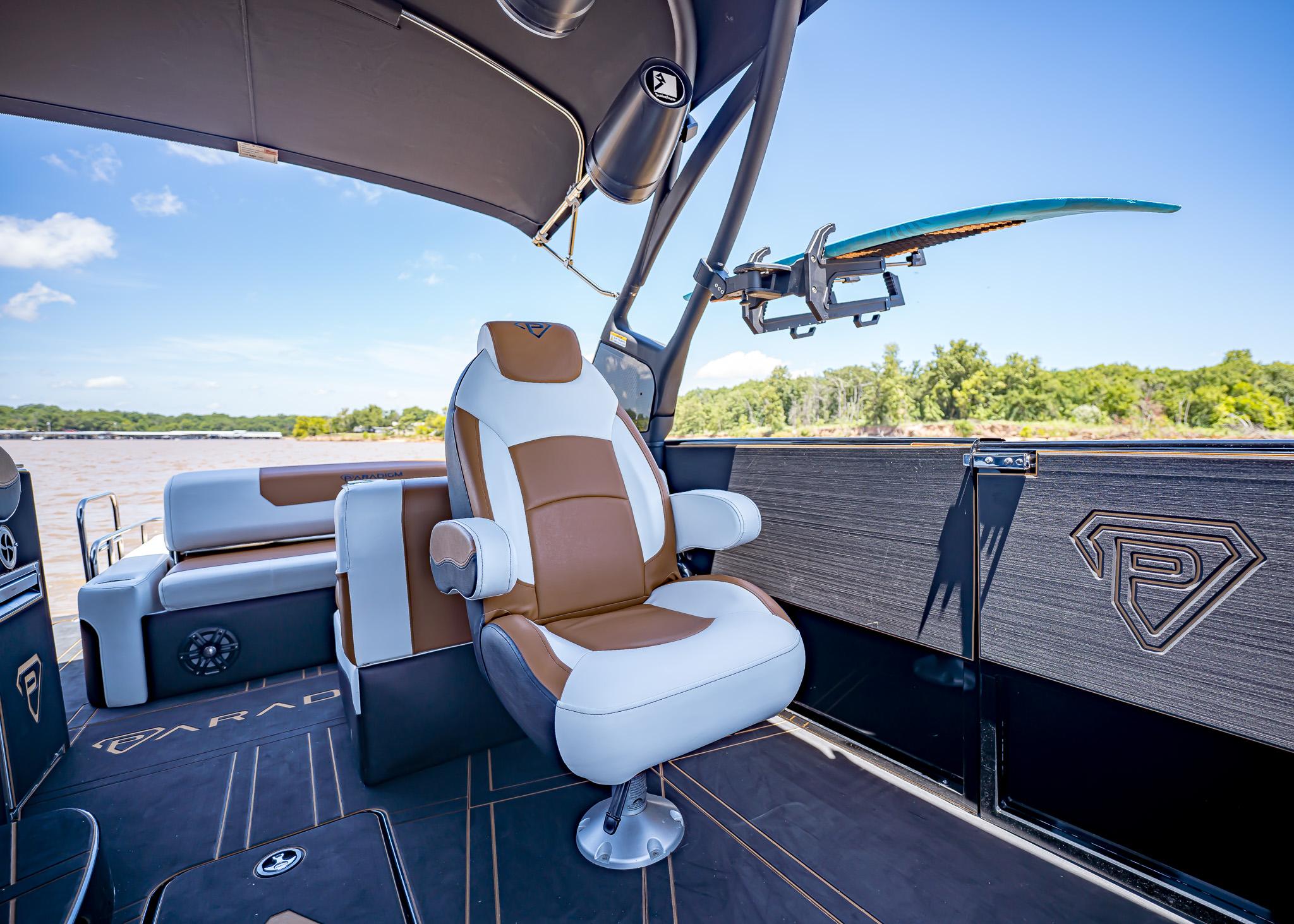 Luxurious Paradigm 236 boat interior with plush seating and surfboard holder, 2025 model.
