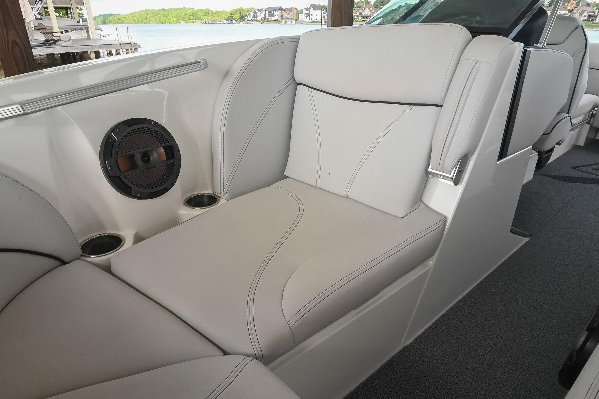 2018 MasterCraft X23 boat interior with cushioned seating and built-in speaker.