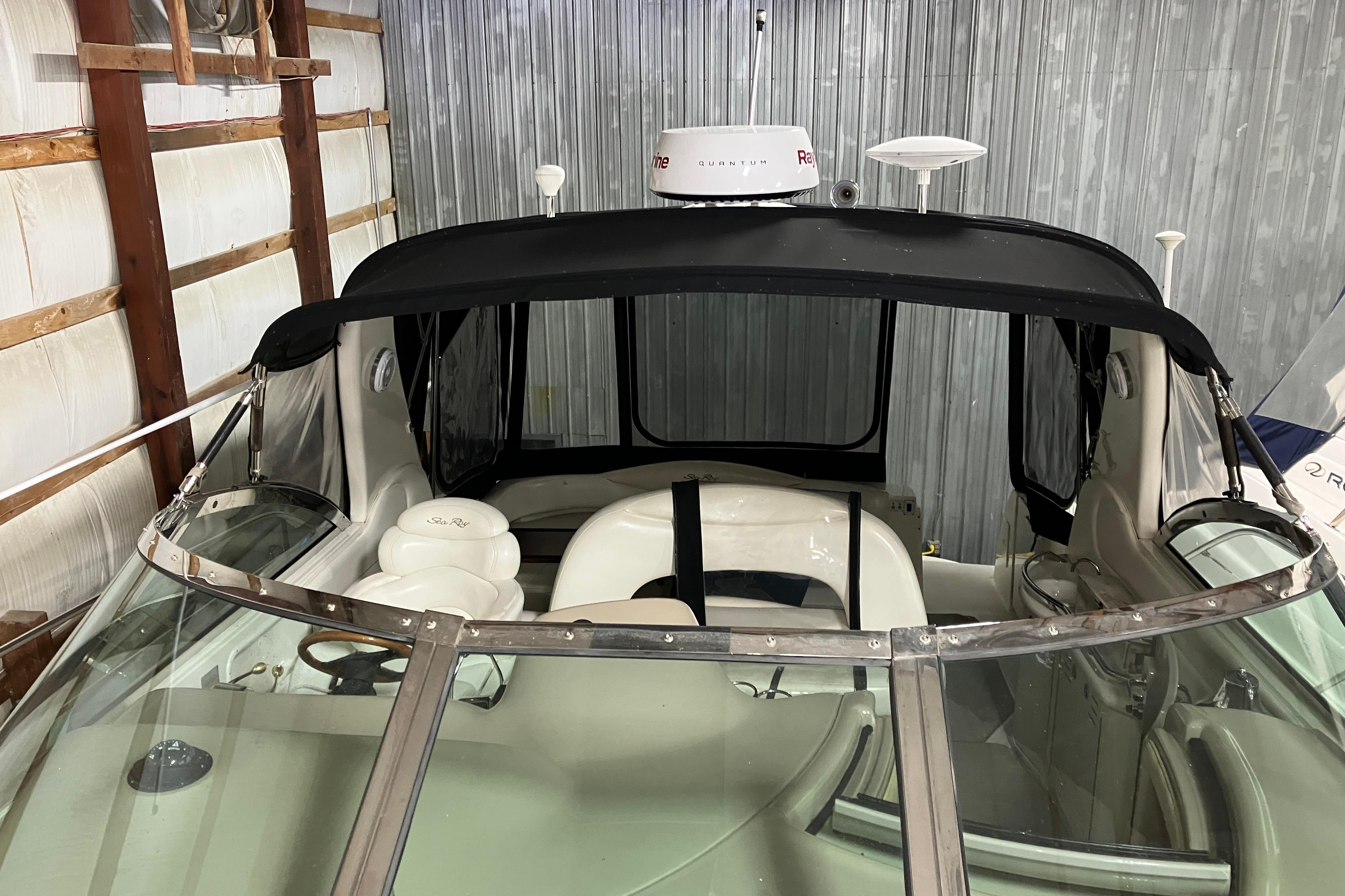 2002 Sea Ray 410 Sundancer boat interior with black canopy in storage.