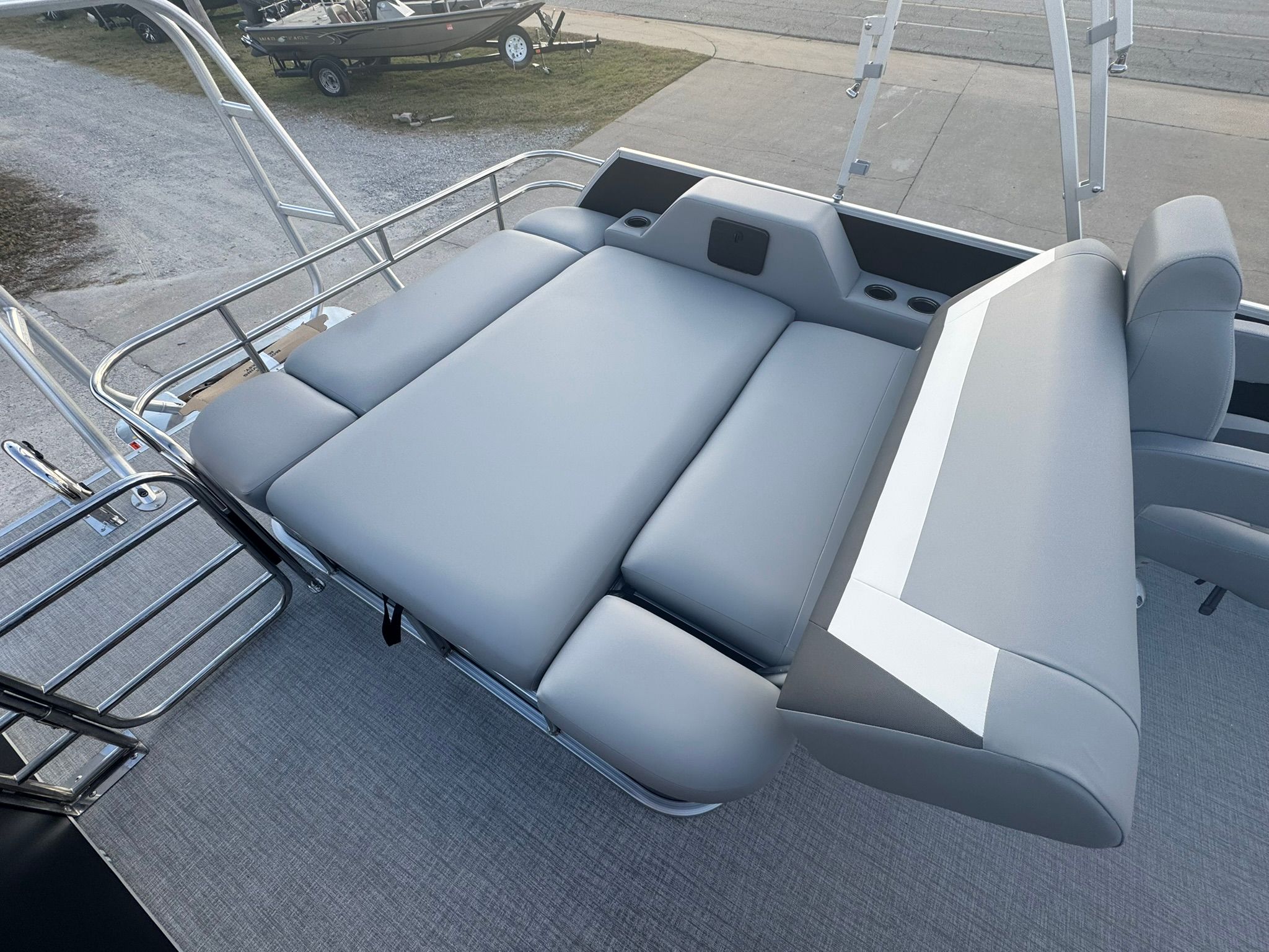 2026 Landau 23 Island Breeze pontoon boat with gray lounge seating.