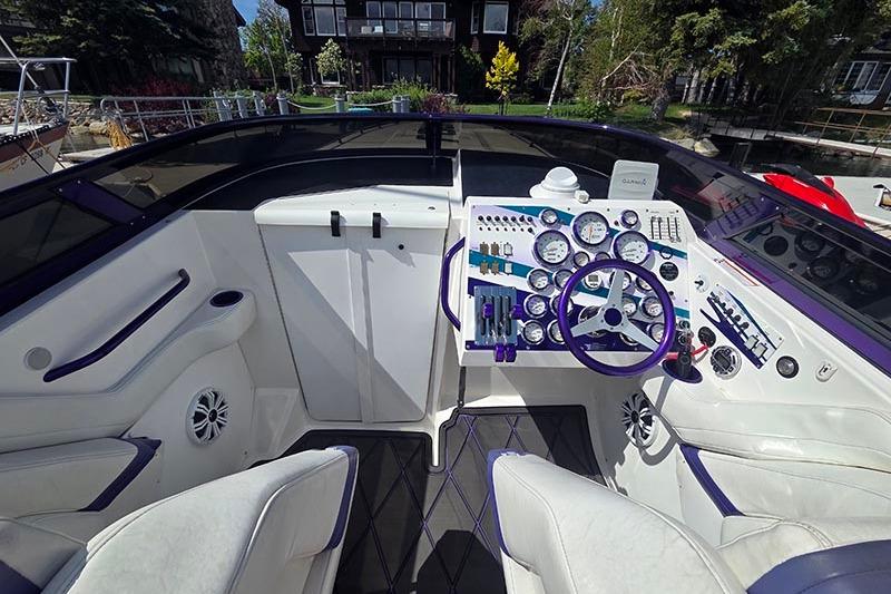 Cockpit of a 2004 Fountain 38 Lightning boat with modern controls and steering wheel.