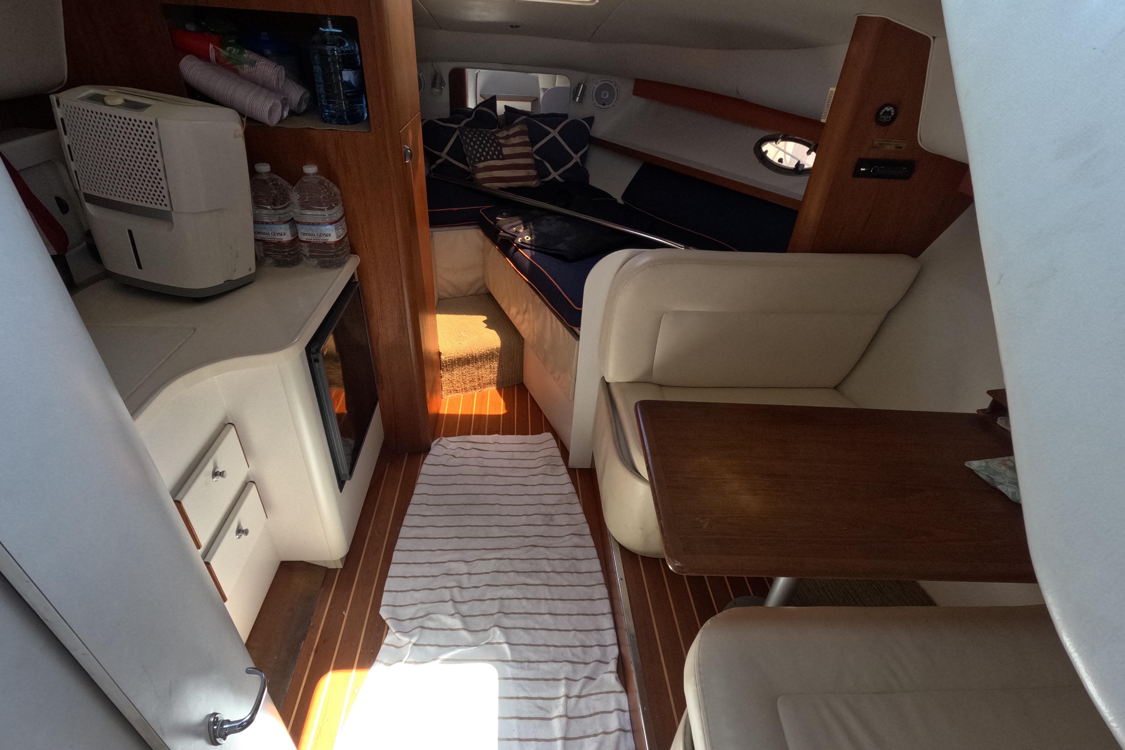 Interior of a 1995 Tiara Yachts 2900 Open, featuring cozy seating and a compact kitchenette.