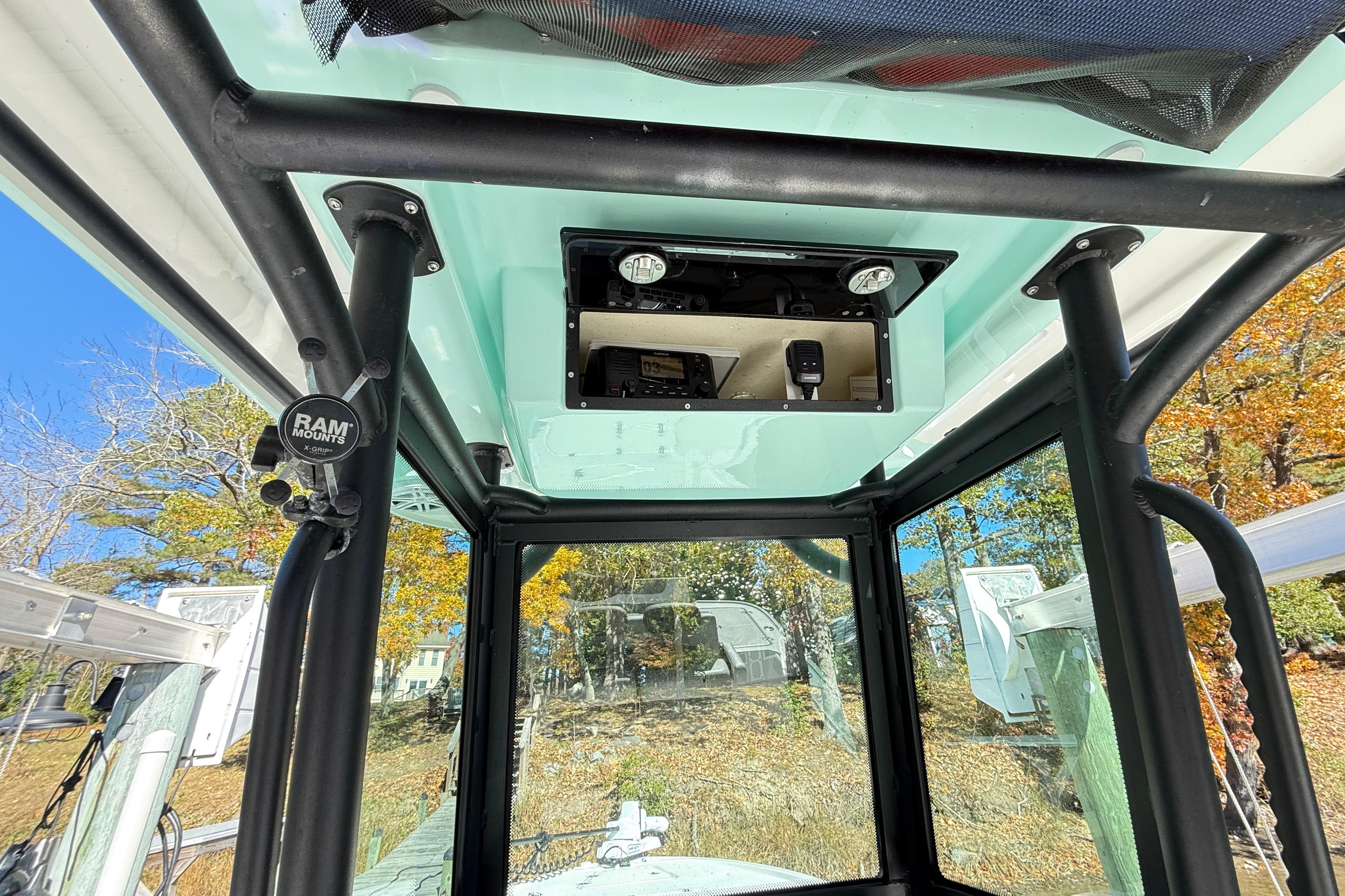 Interior view of 2023 Caymas 281 HB boat with mounted equipment and clear windows.