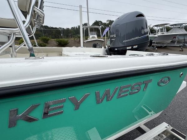 2025 Key West 179 FS boat with Yamaha 115 engine, teal hull, in a marina setting.