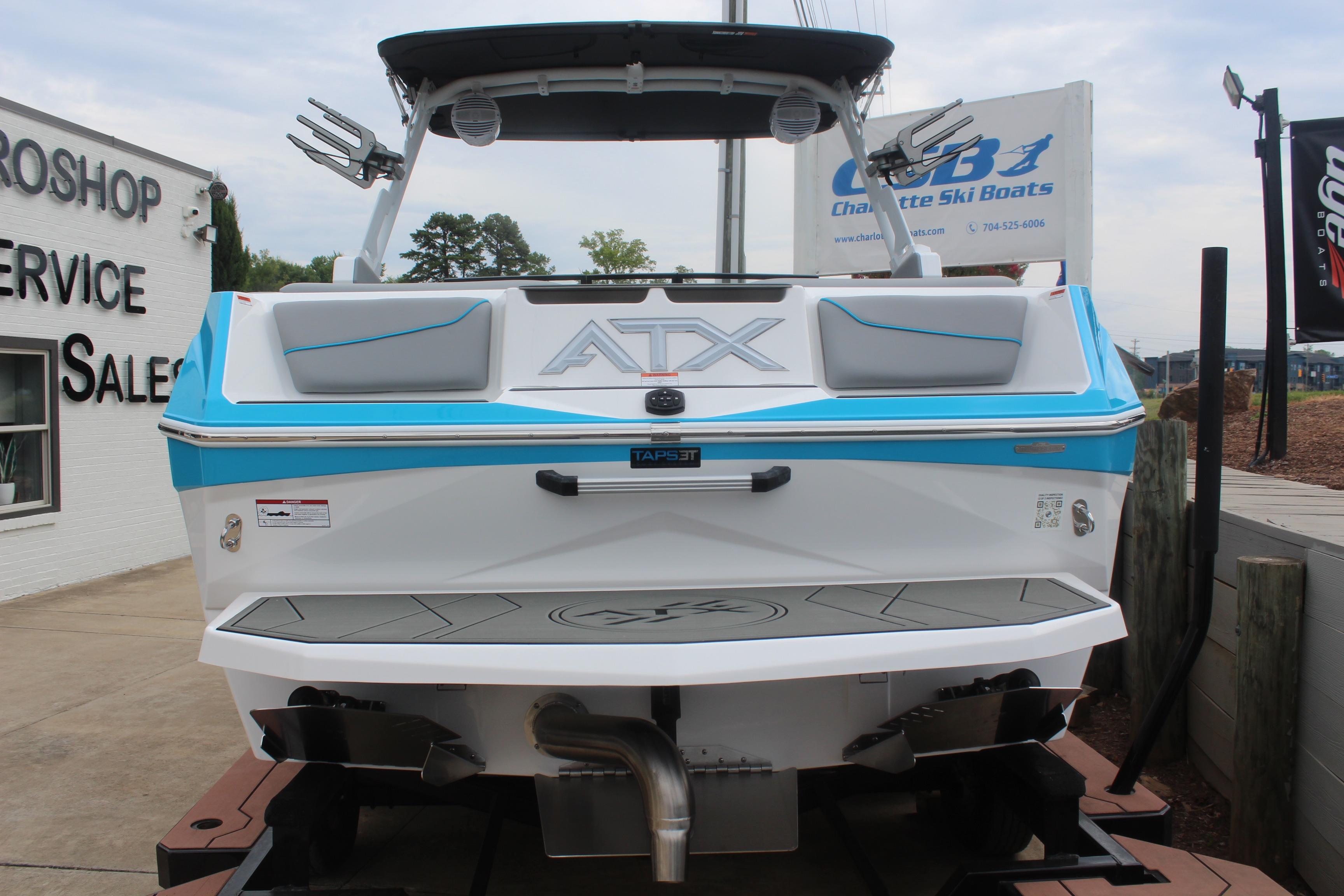 2026 ATX Surf Boats 22 Type-S displayed at a dealership, showcasing its sleek design.