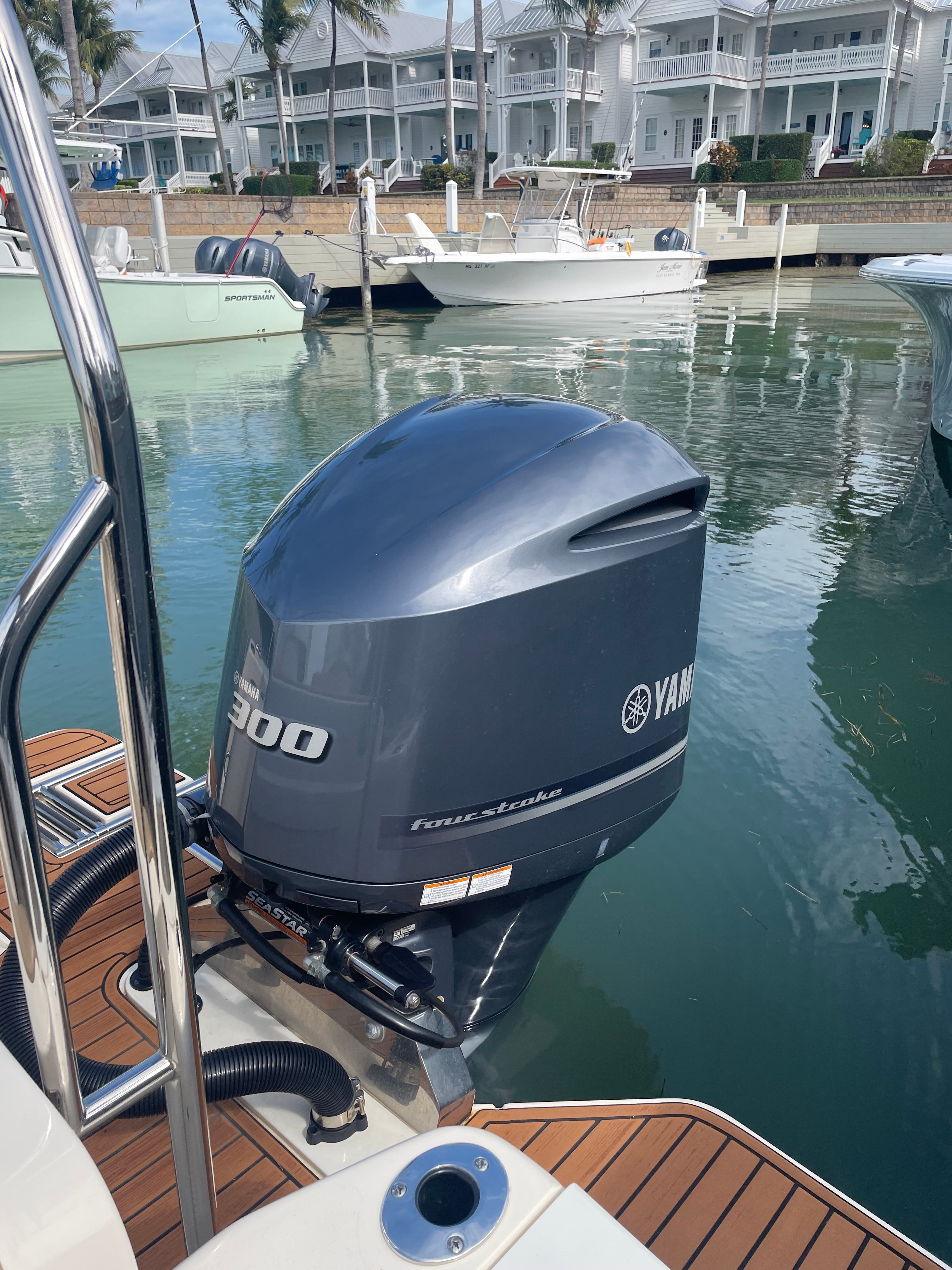 A 2020 Scout 235 Dorado with a Yamaha 300 outboard motor docked in a marina.