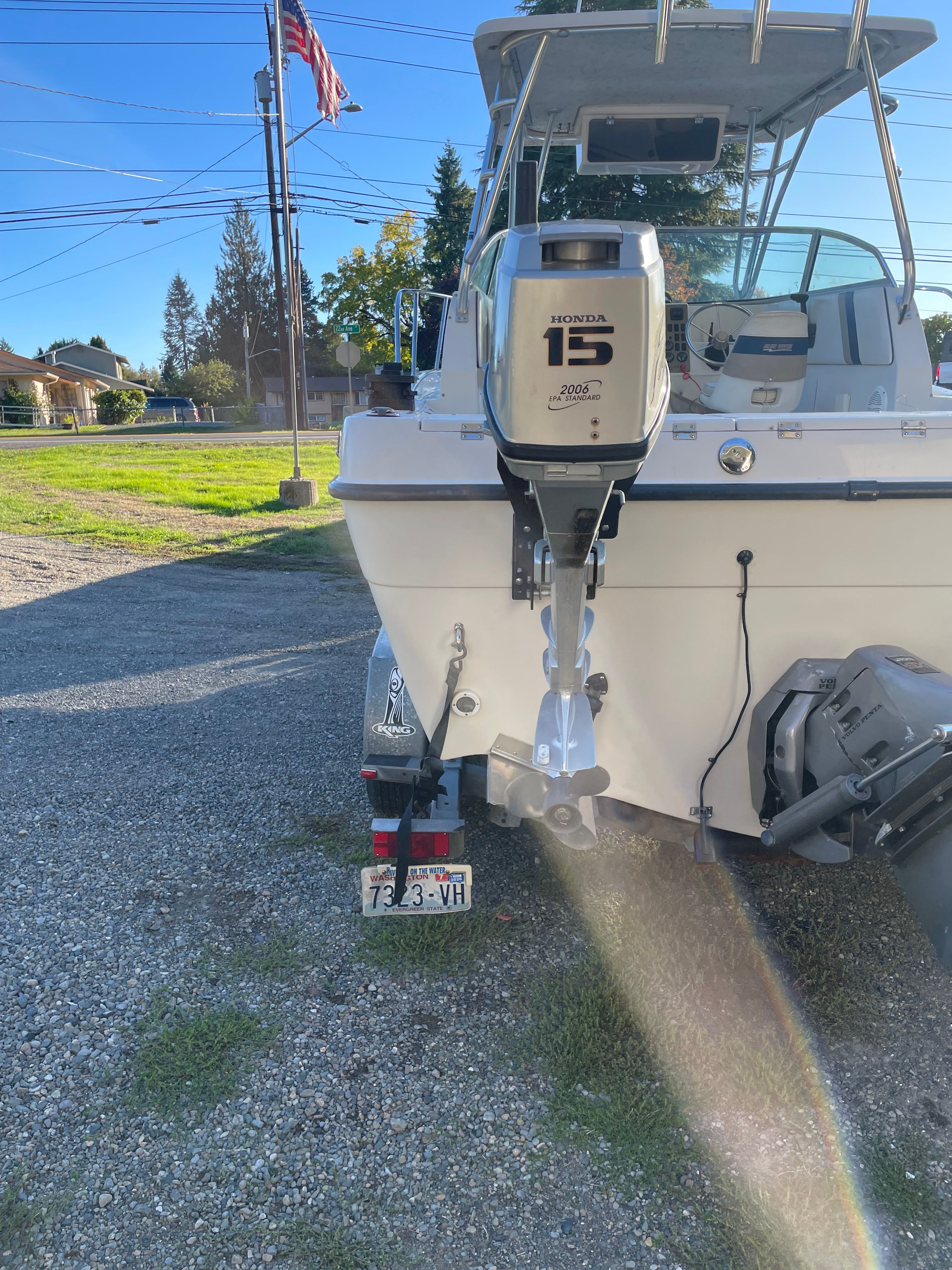 Rear view of a 2001 Bluewater 2100 sport fisher with a Honda outboard motor on a trailer.