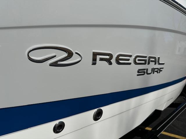 2025 Regal LS4 Surf boat logo on white hull with blue stripe.