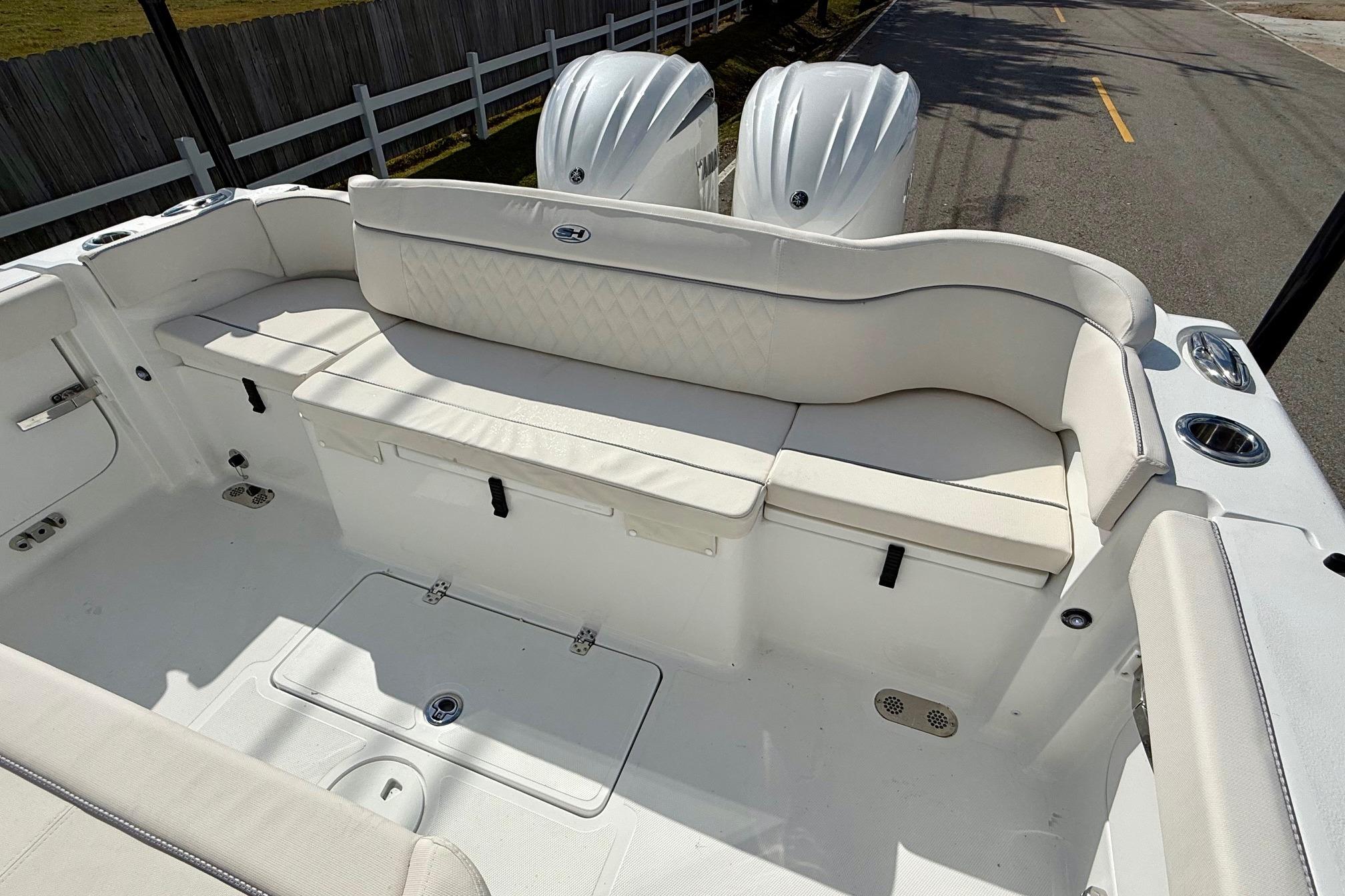 2026 Sea Hunt Ultra 285 Coffin Box boat interior with white seating and dual engines.