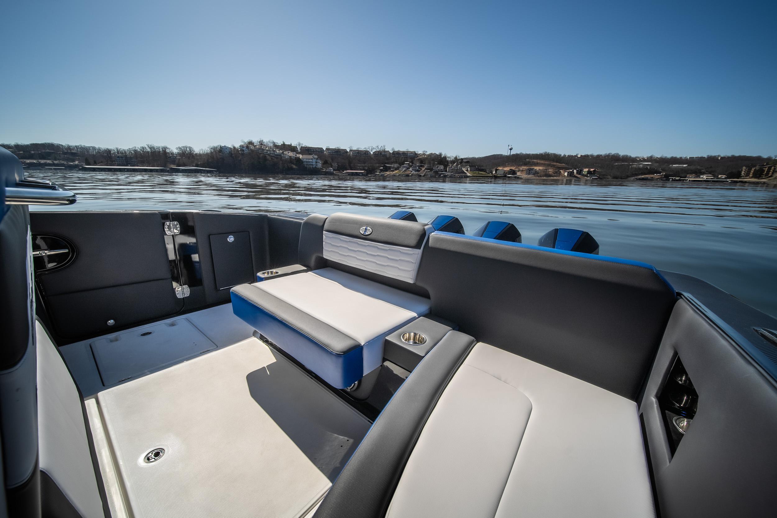 2025 Cigarette 42 Auroris boat interior with sleek seating on a calm lake.