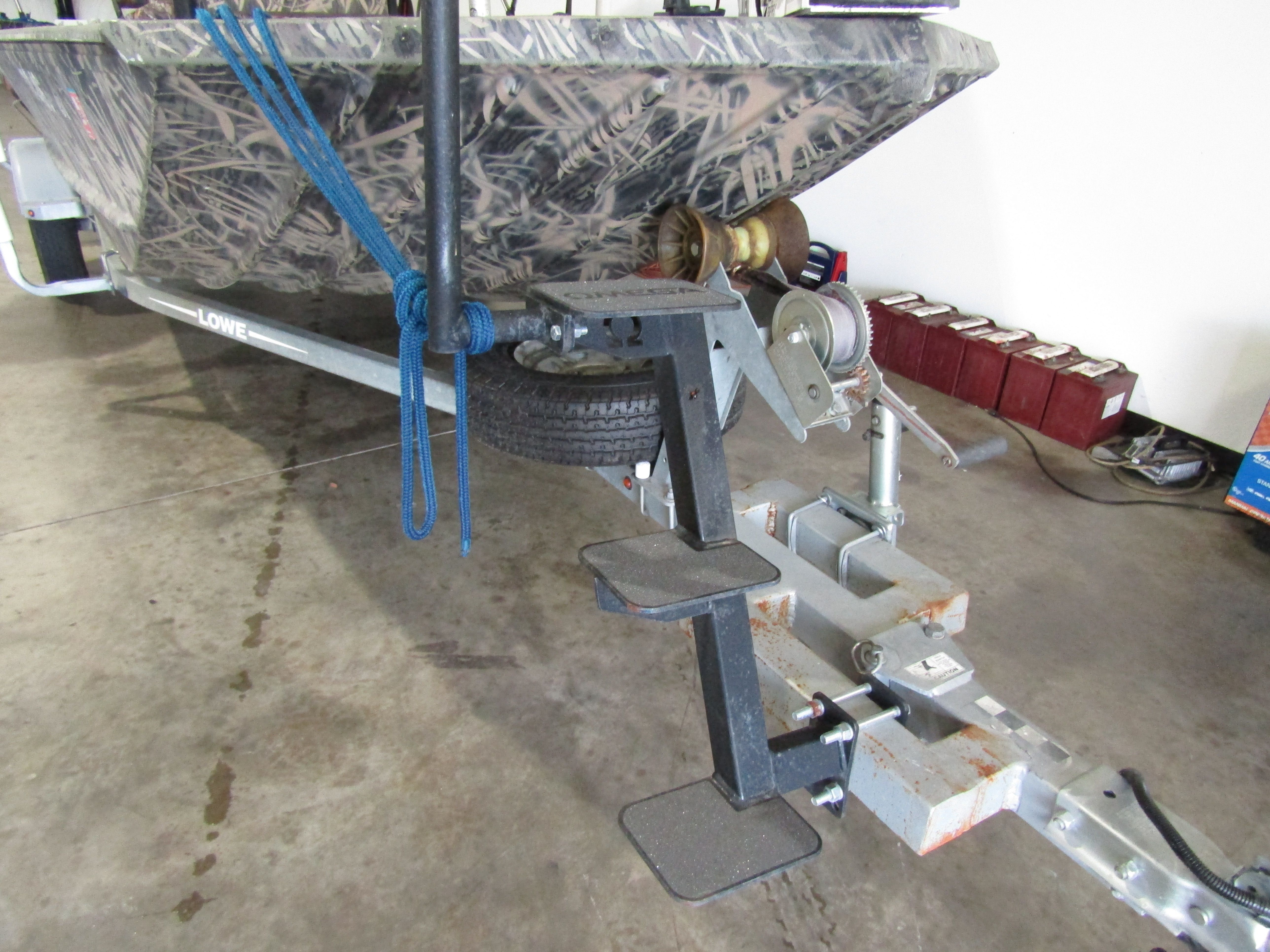 A 2016 Lowe 186 boat on a trailer in a garage.