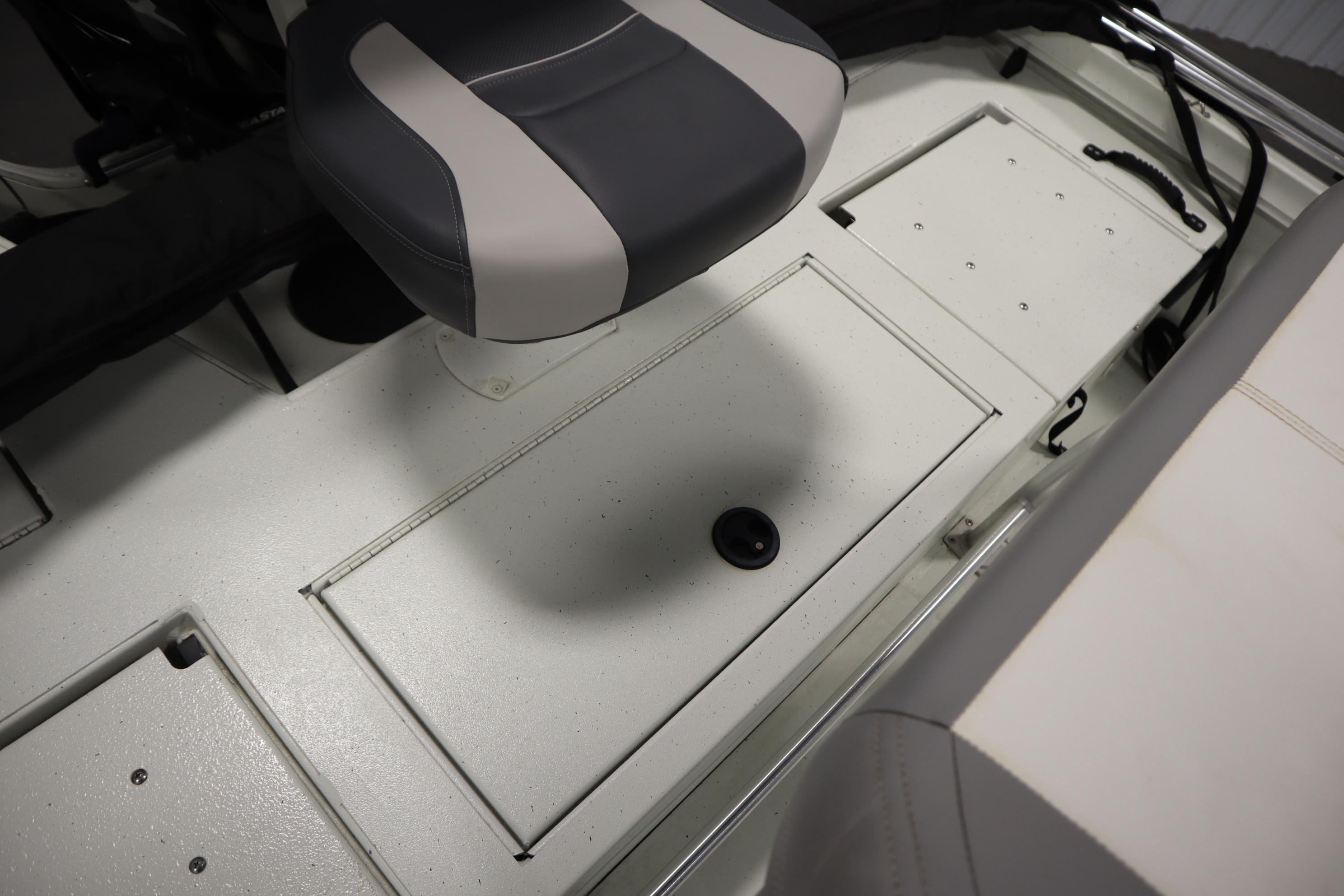 Interior of 2022 Crestliner 2200 CC boat showing seating and storage compartments.