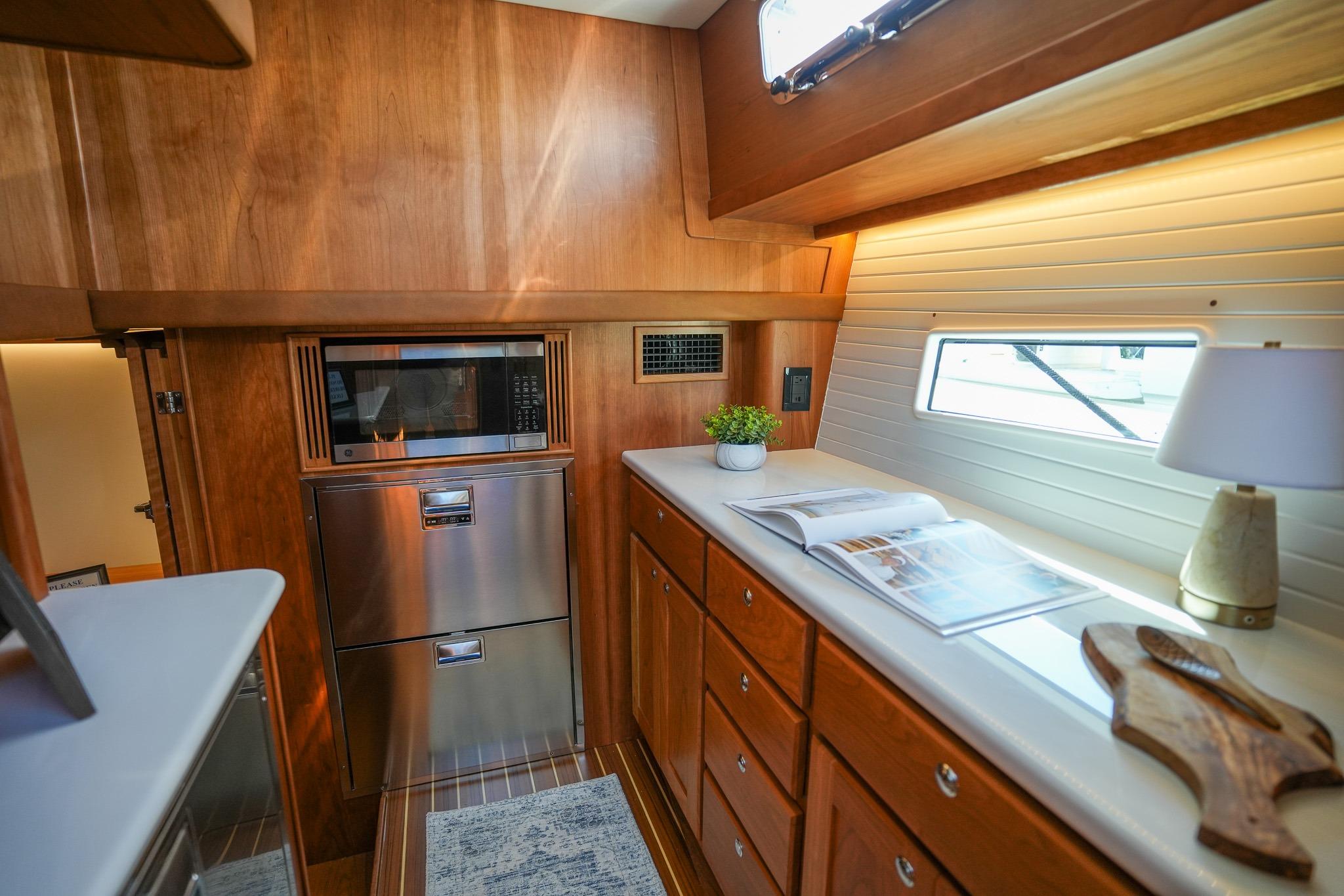 Luxurious 2026 Sabre 51 Salon Express yacht interior with modern kitchen amenities.