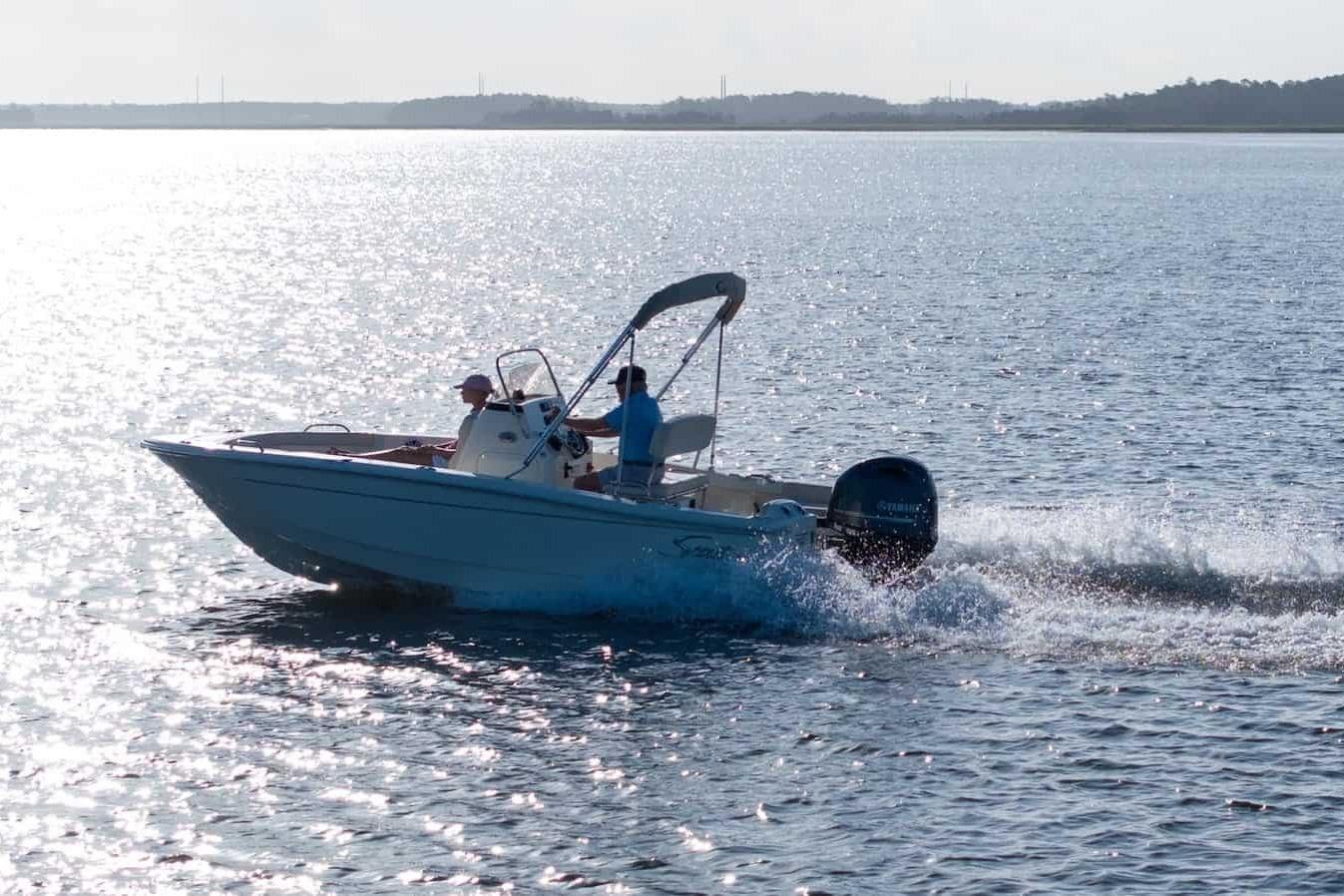 2026 Scout 188 Sportfish boat cruising on a sunny, sparkling water surface.