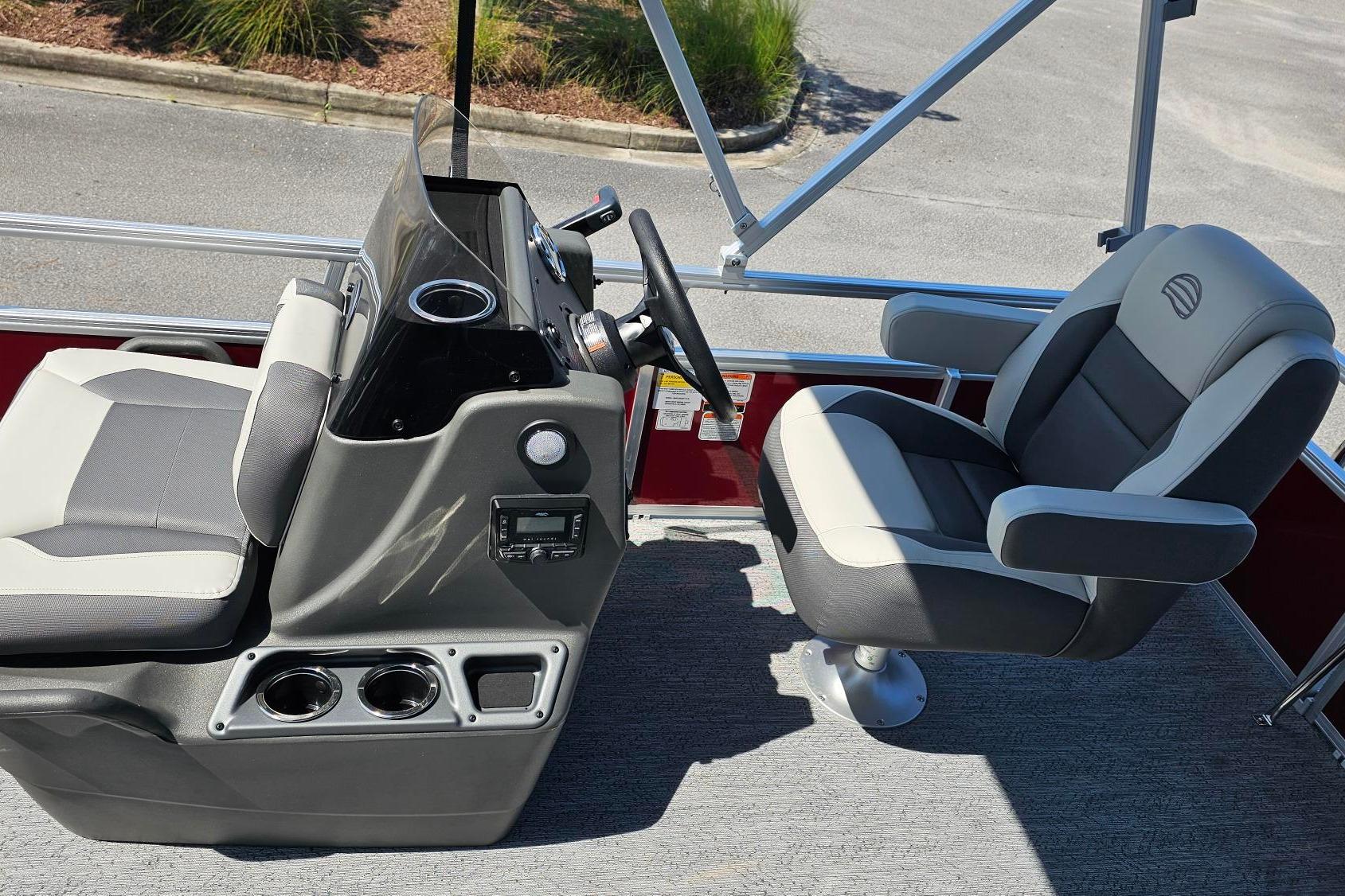 Interior of 2026 Sun Tracker Bass Buggy 16 XL Select pontoon boat with steering console and seating.