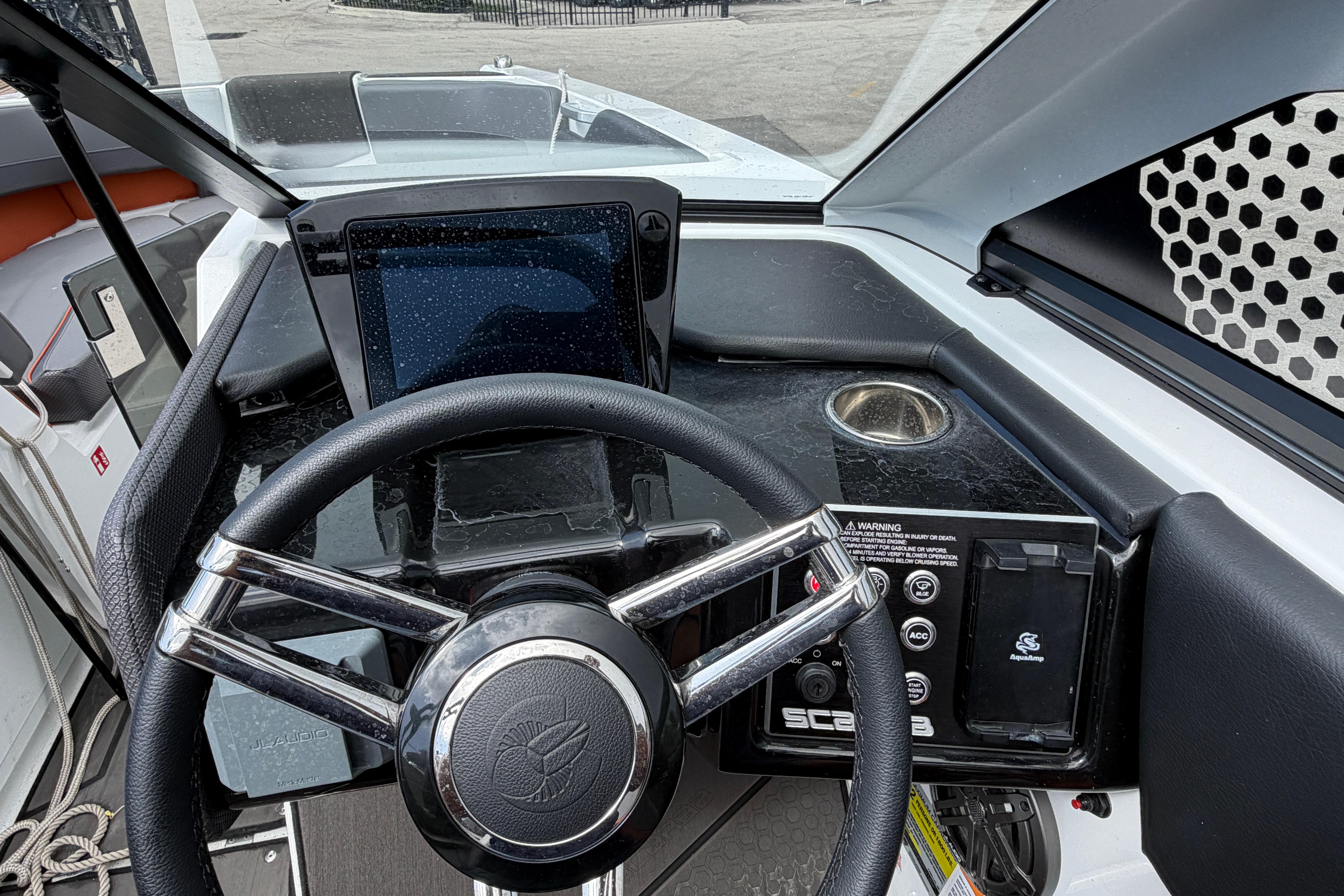 2026 Scarab 235 LX boat dashboard with steering wheel and control panel.