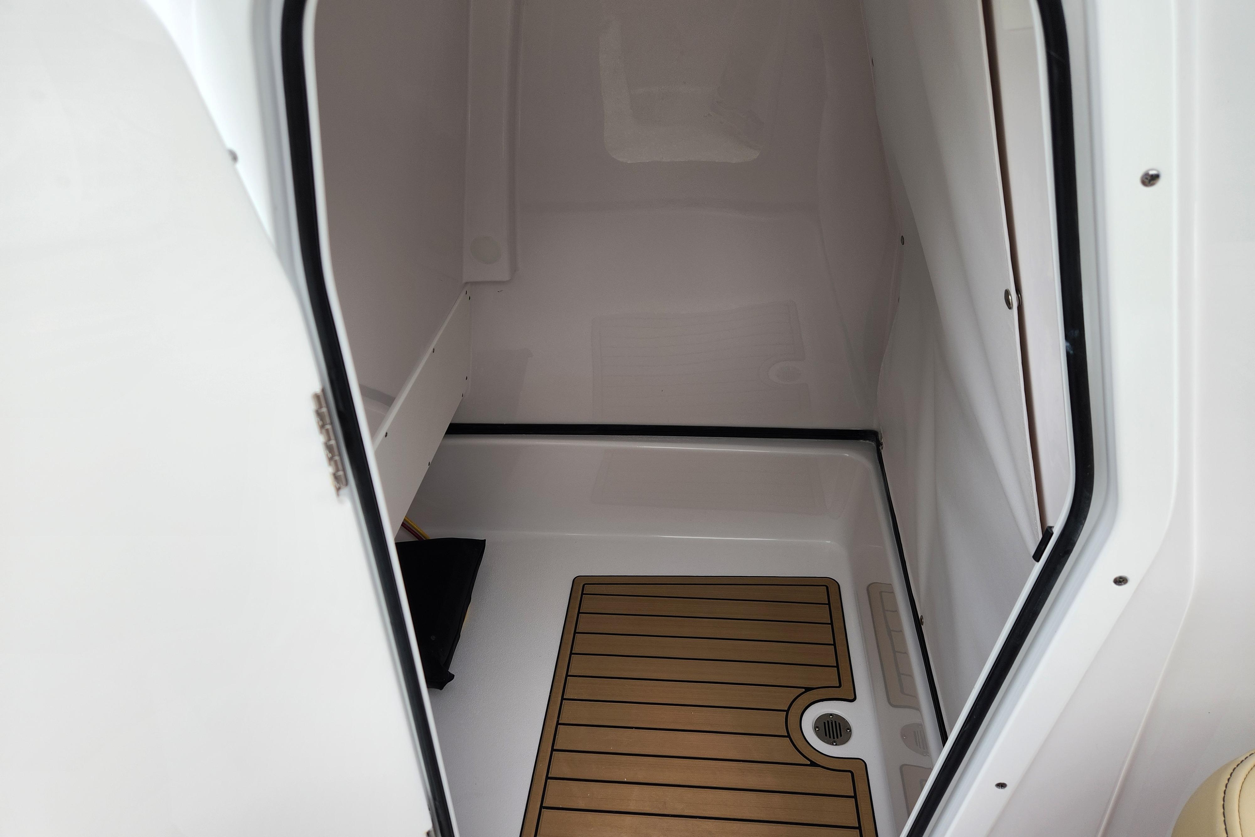 2026 Sportsman Masters 247 Bay Boat interior cabin with wood-patterned flooring.