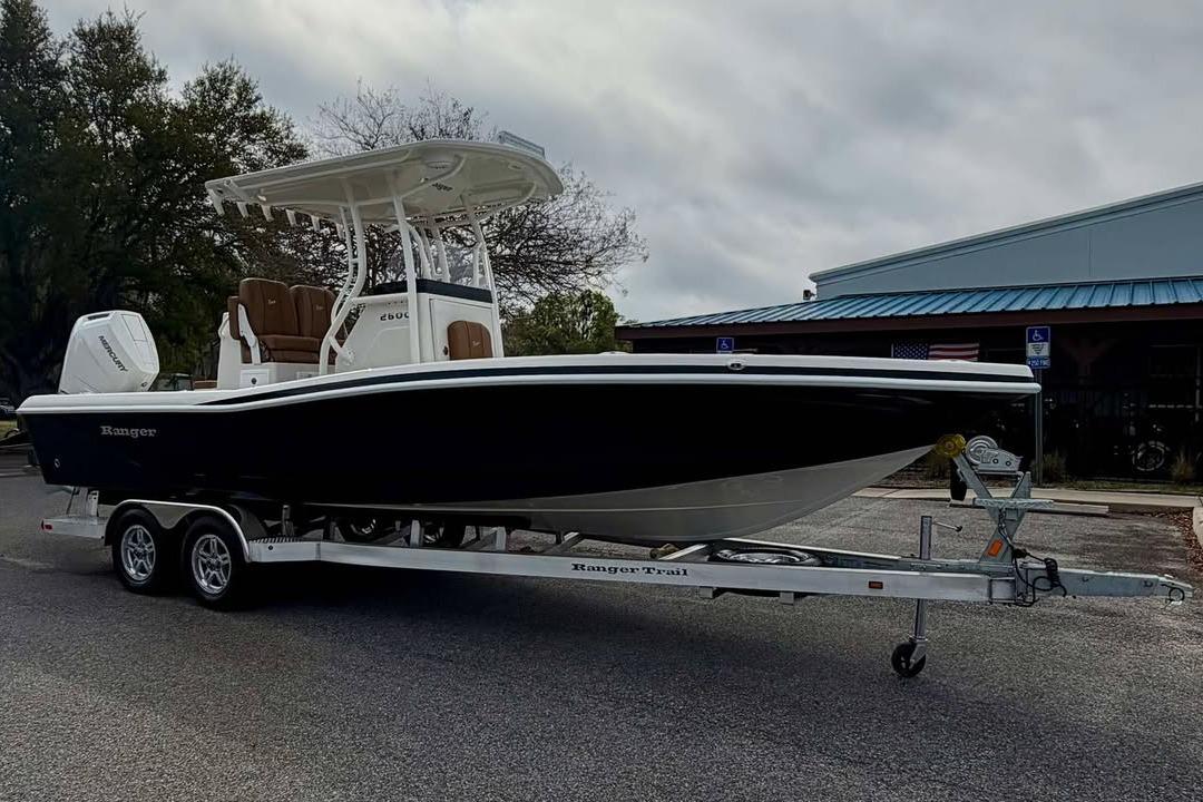 2026 Ranger 2600 Bay boat on trailer, parked outdoors near a building.