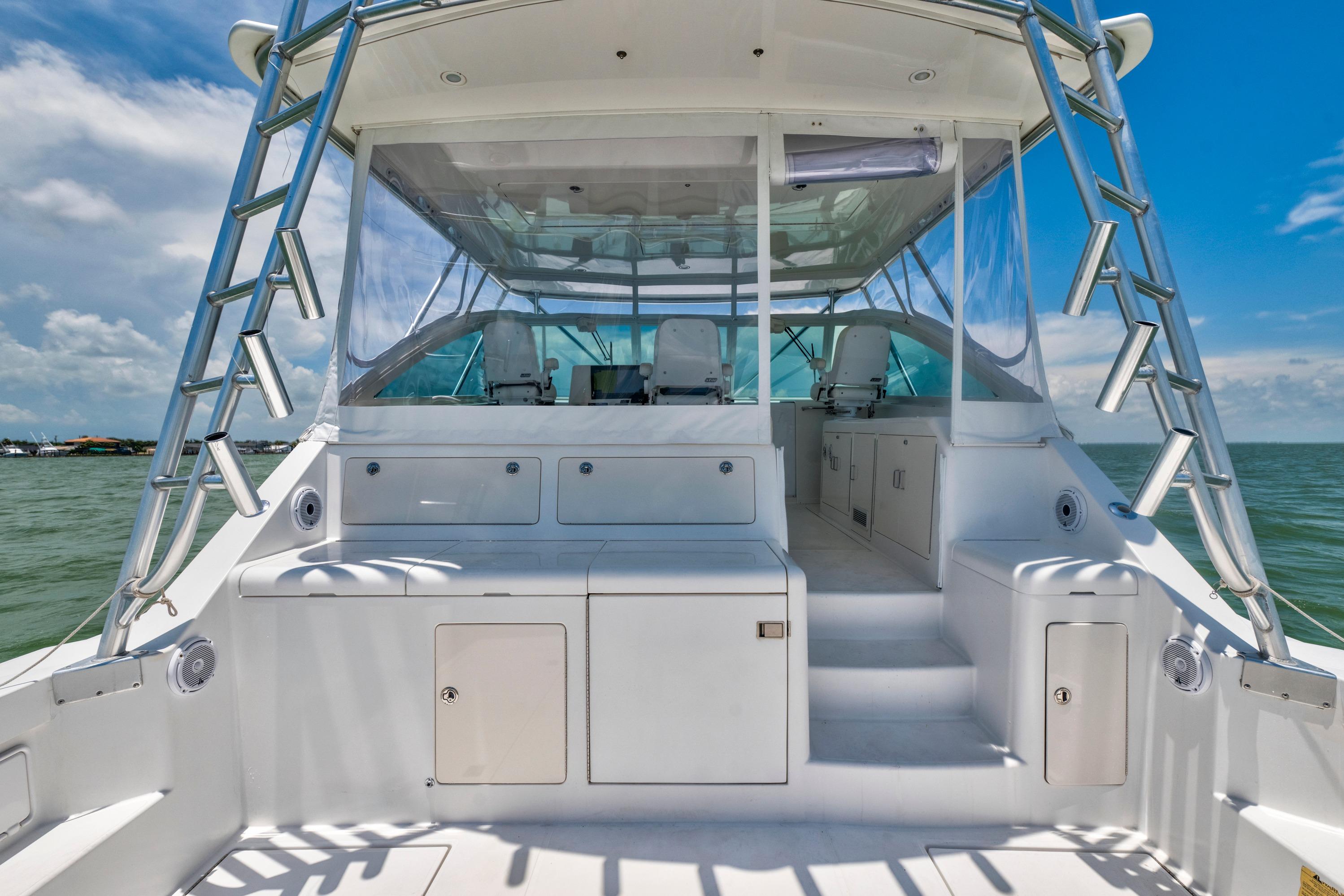 2010 Cabo 45 Express yacht interior with seating, ocean view, and clear skies.