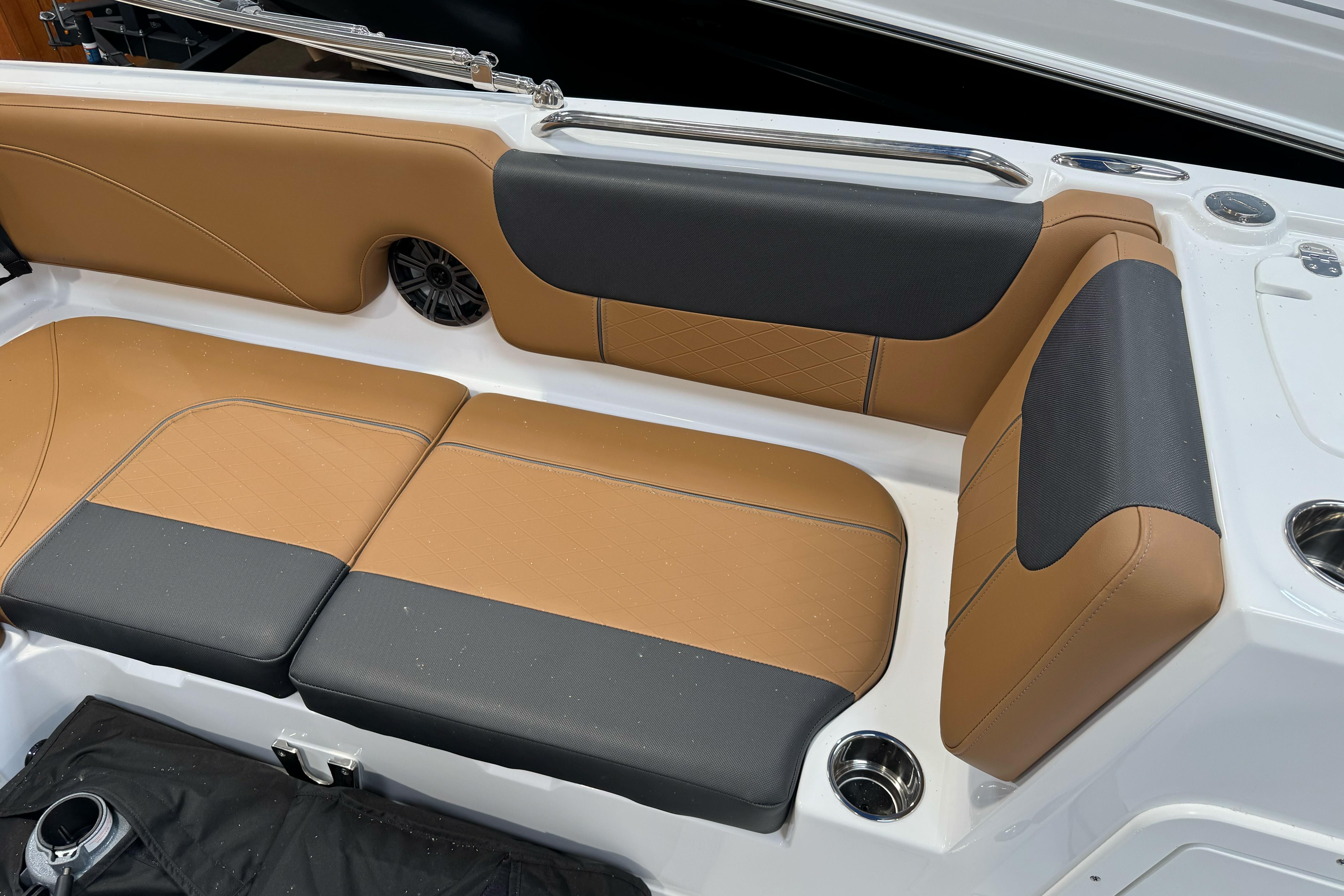 2026 Tahoe 2150 boat interior with tan and black cushioned seating.
