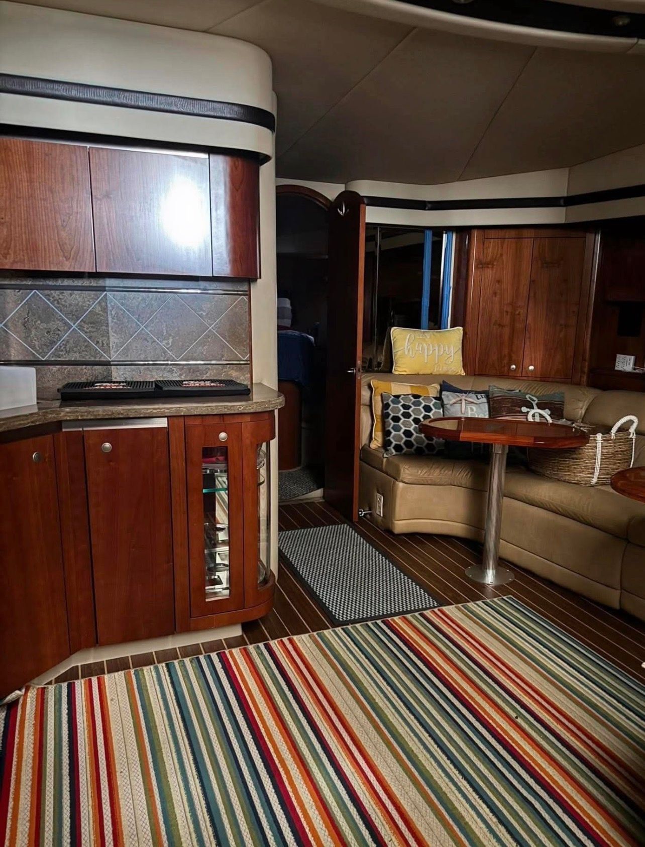 Interior of a 2009 Cruisers Yachts 520 Sports Coupe with wood furnishings and striped rug.