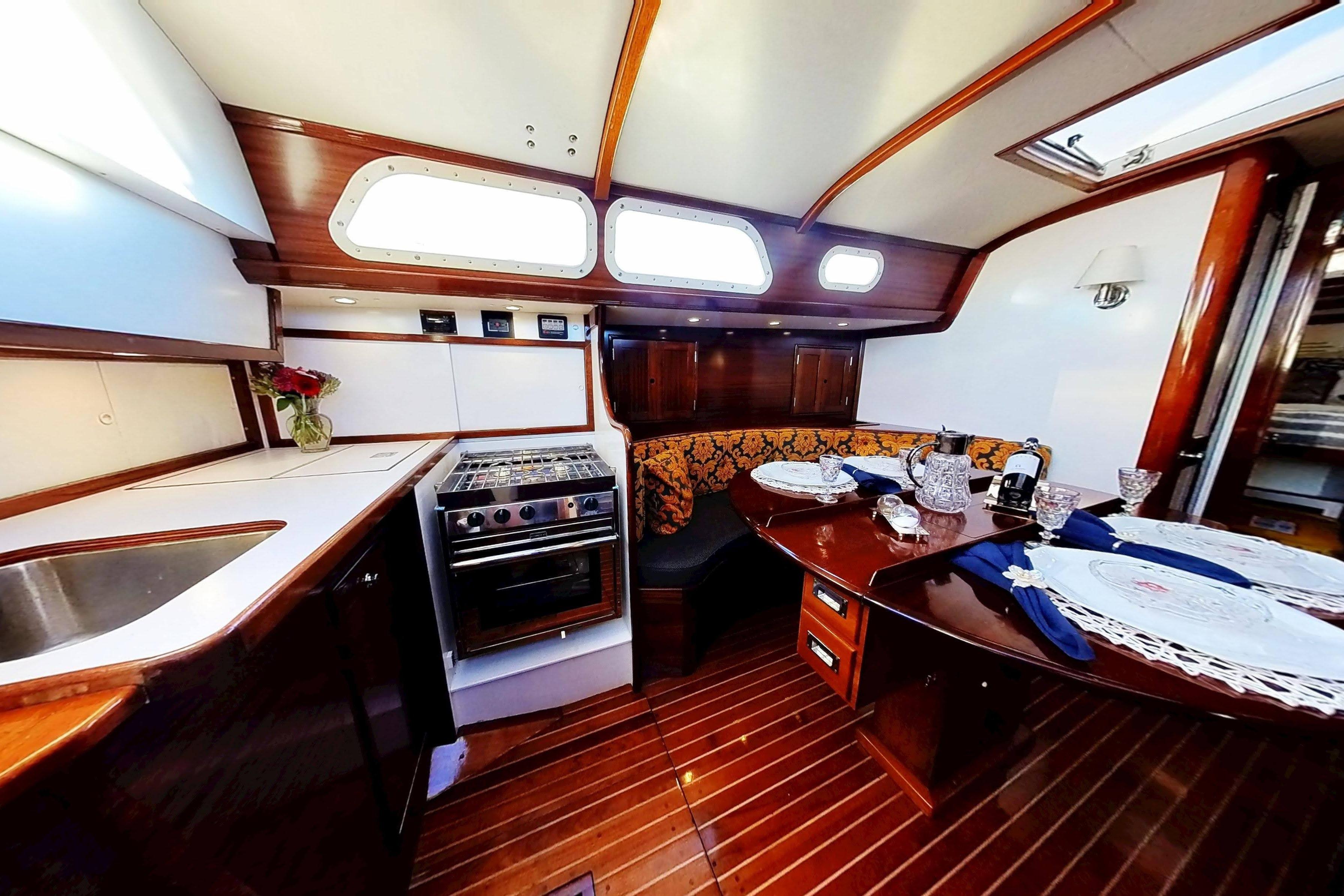 Interior of 1970 Hinckley Bermuda 40 yacht with elegant dining area and kitchen.