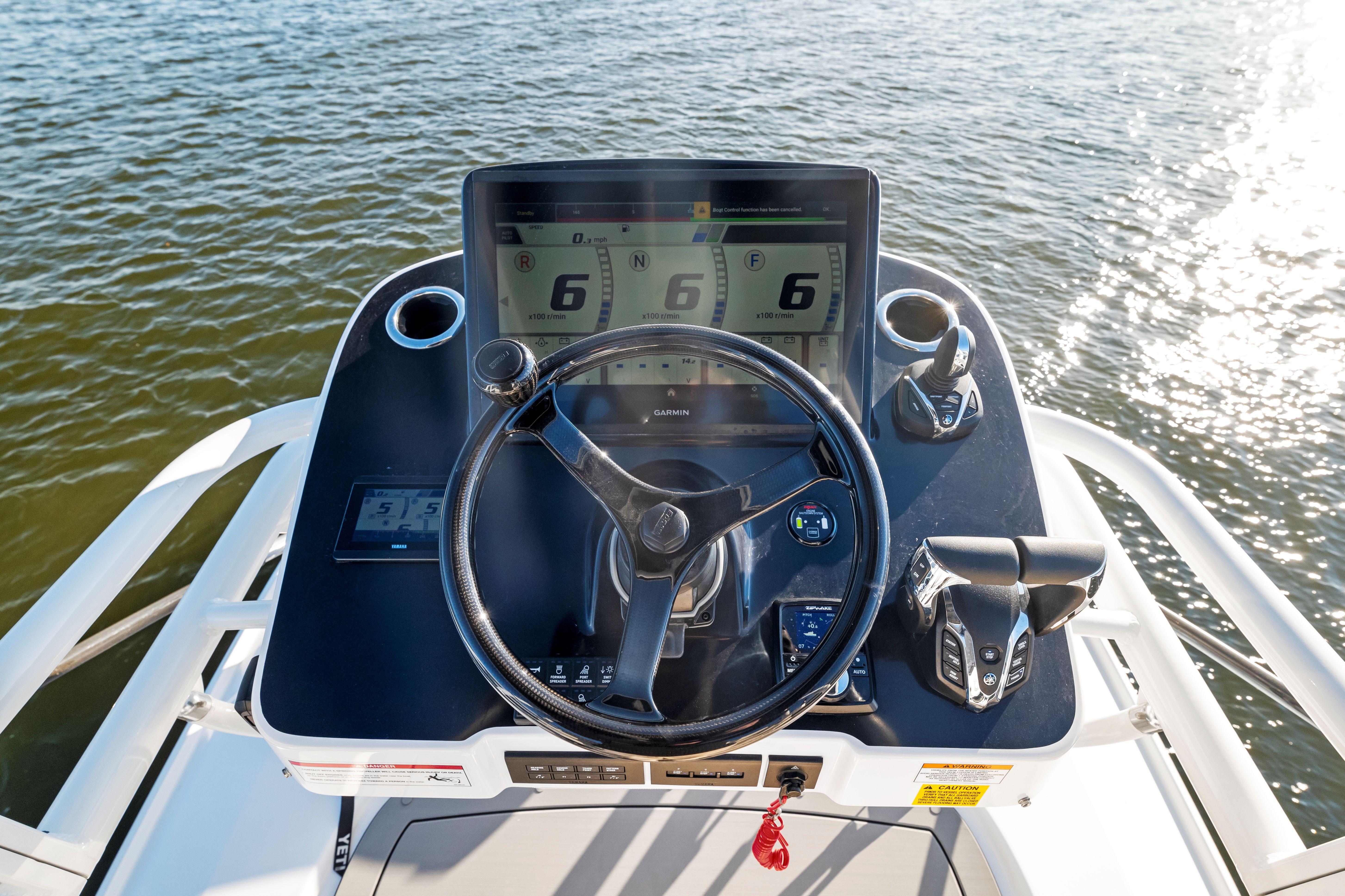 2026 Everglades 375 Center Console boat helm with advanced navigation system on water.