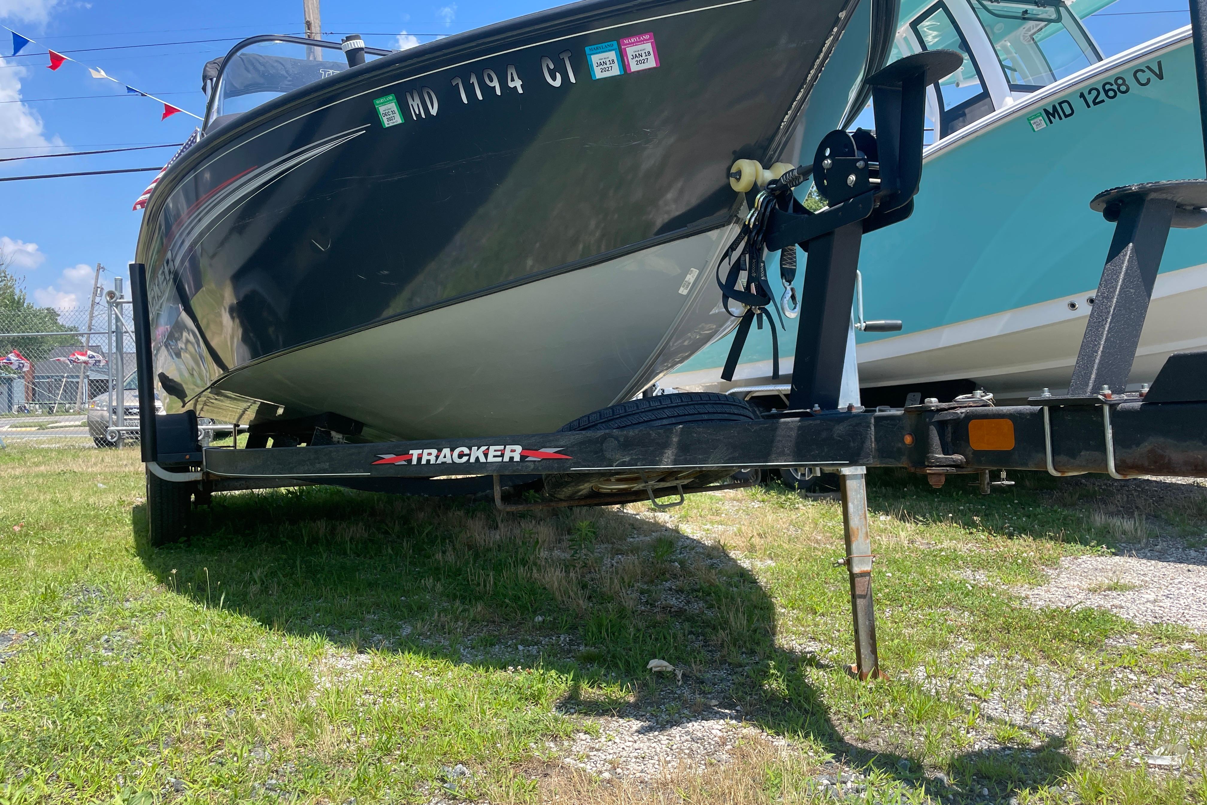 2022 Tracker Targa V-18 WT boat on trailer, parked on grass.