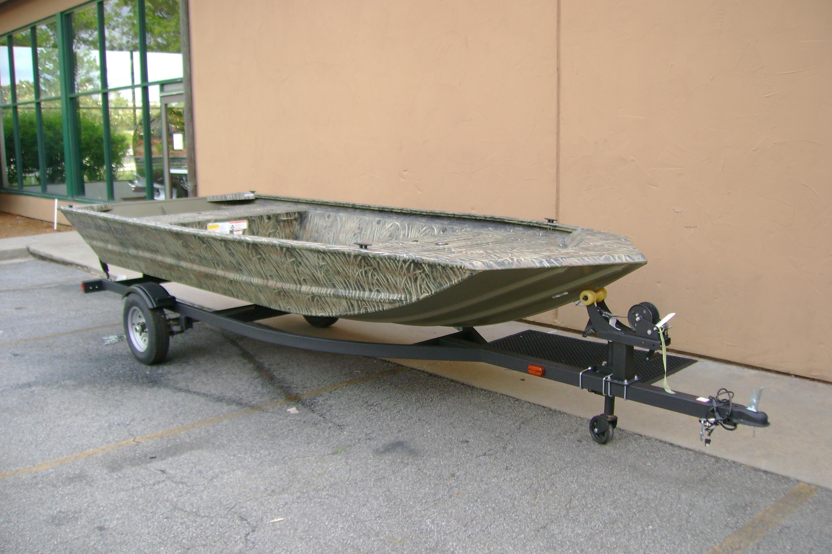 2026 Tracker Grizzly 1648 Utility boat on trailer, parked outdoors.