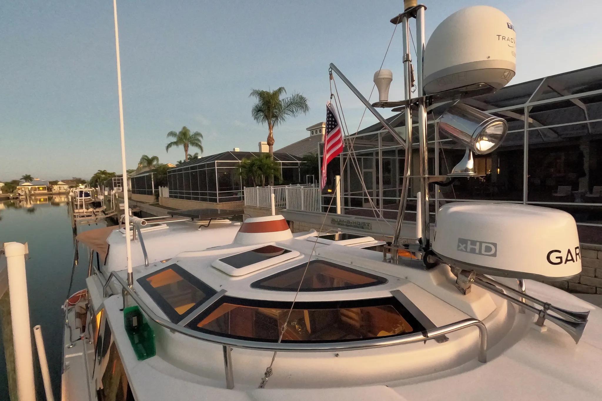 2015 Ranger Tugs R-29 S boat docked, featuring radar and American flag.