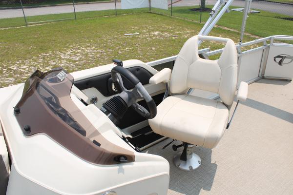 2021 Tahoe LTZ Cruise boat helm with beige captain's chair and steering wheel.