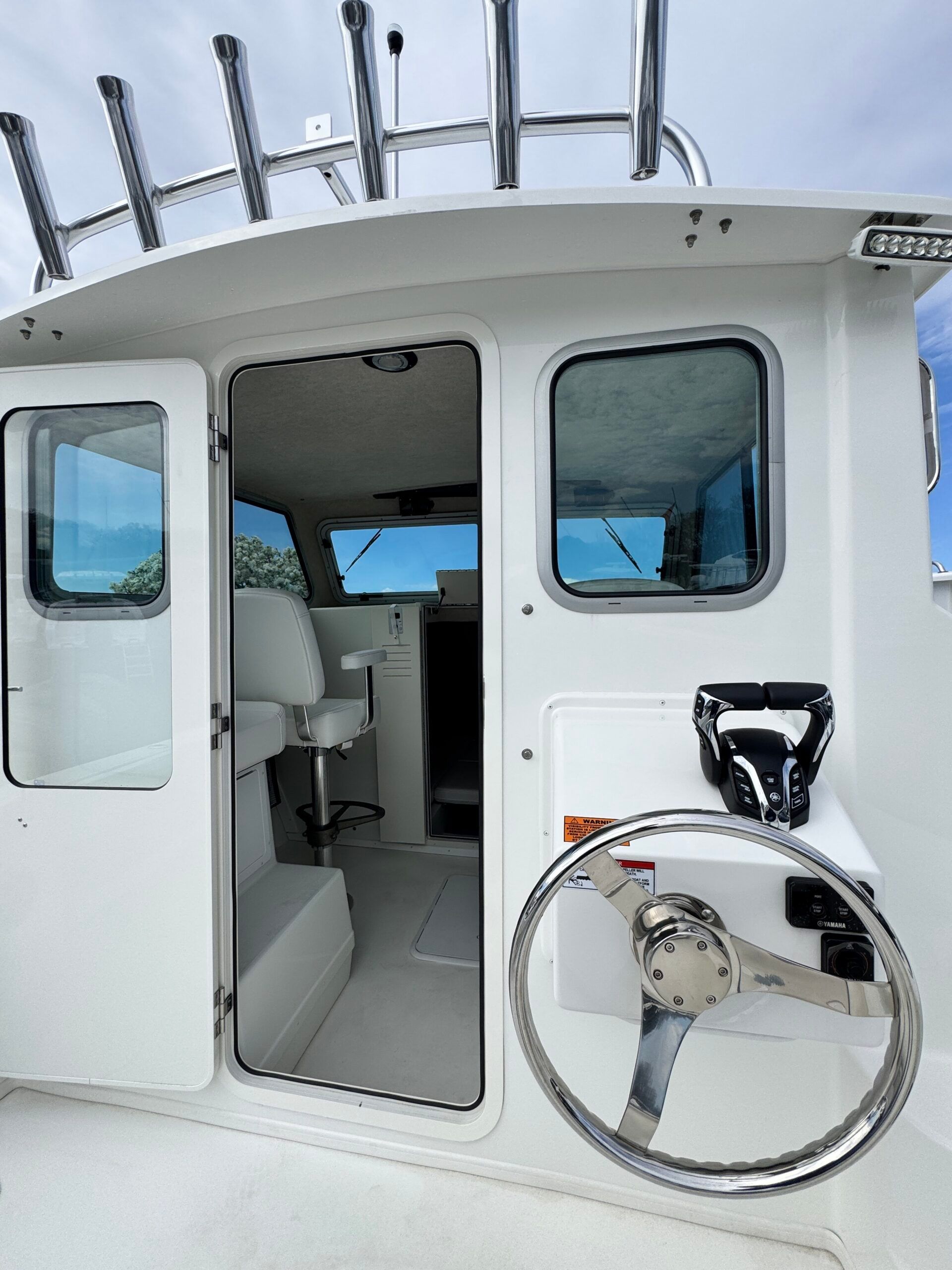 The image shows the cockpit of a 2021 Regal 26 Express boat with a helm station.