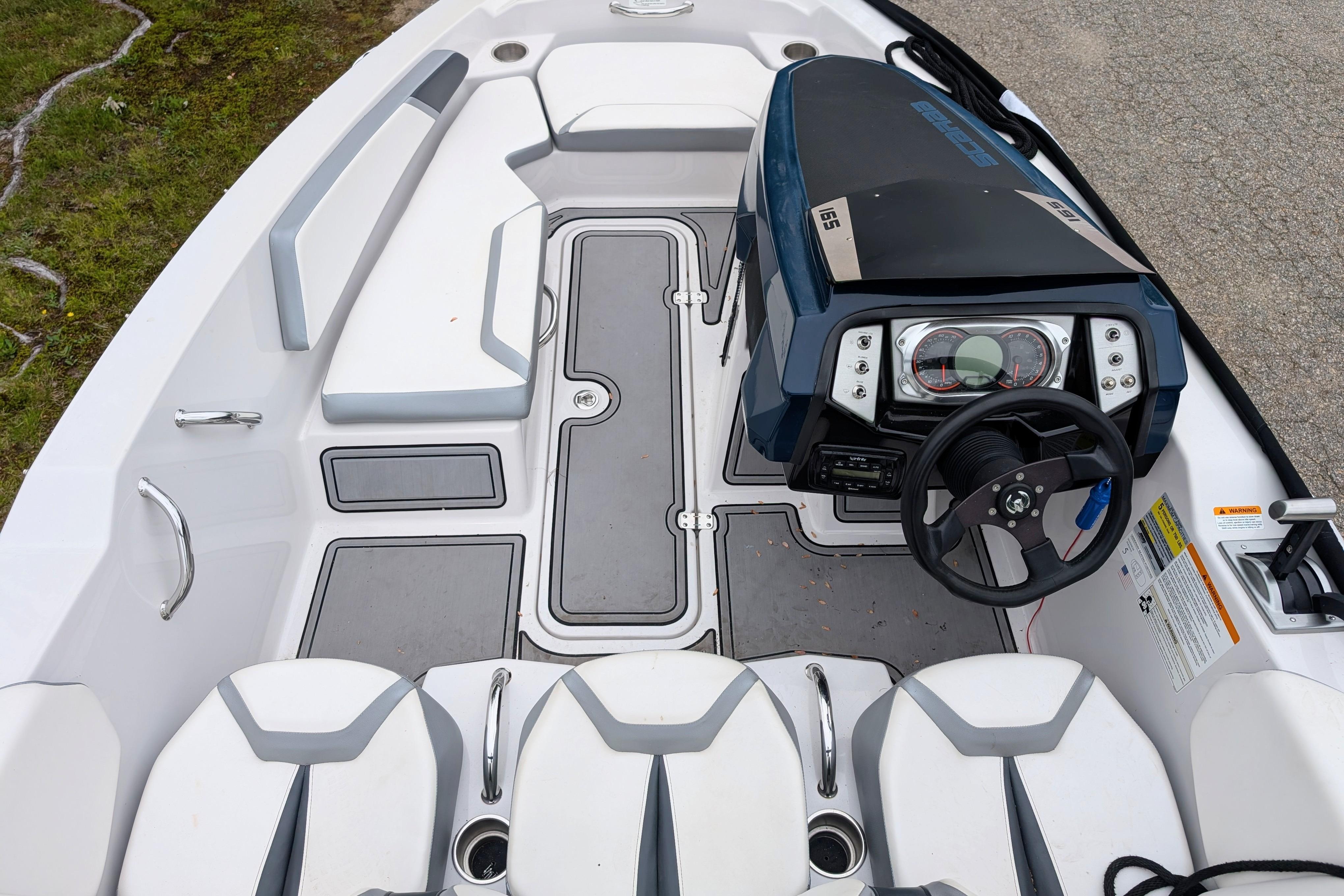 2016 Scarab 165 ID boat interior with steering wheel and seating arrangement.