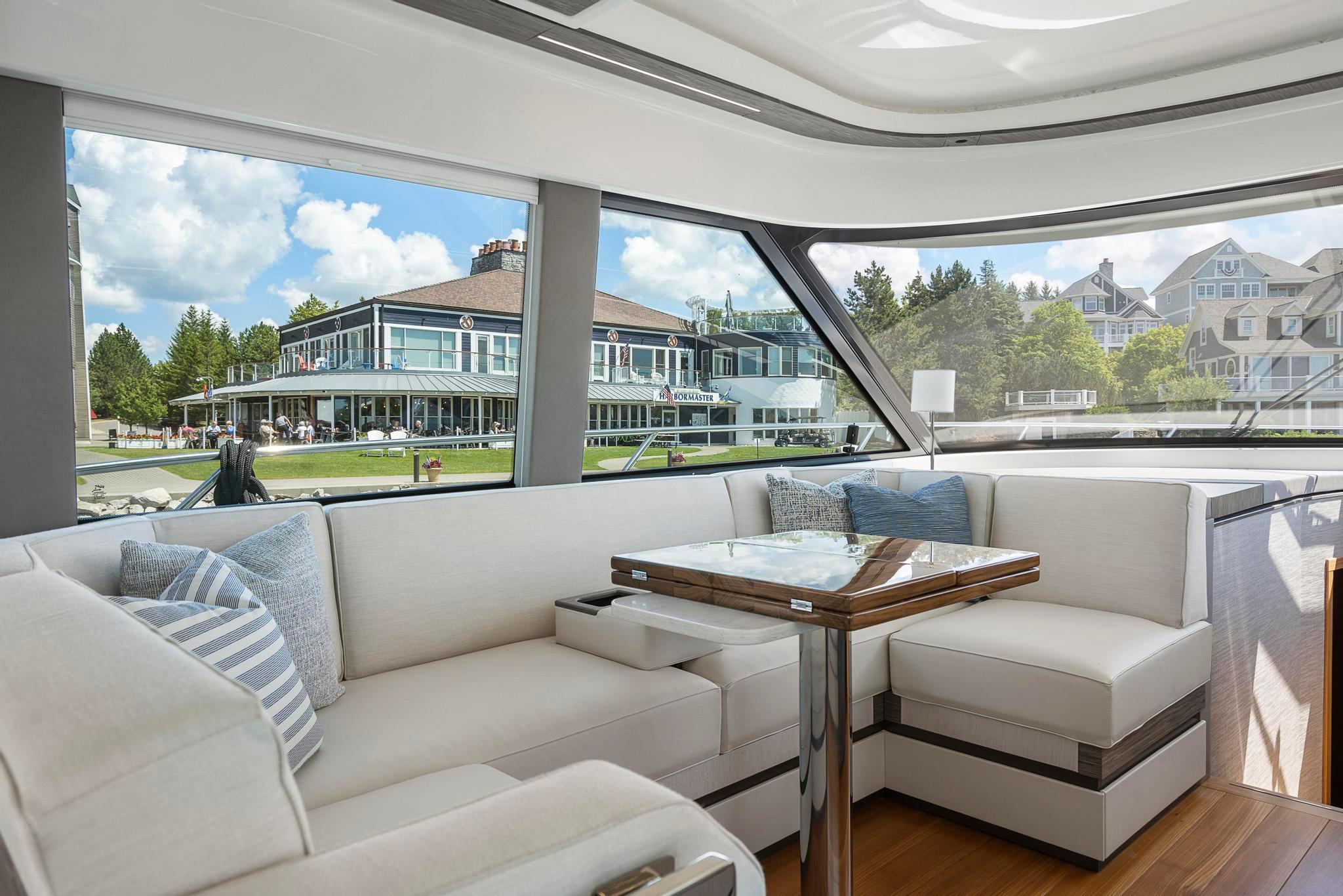 Luxurious interior of 2022 Tiara Yachts C49 Coupe with elegant seating and scenic view.