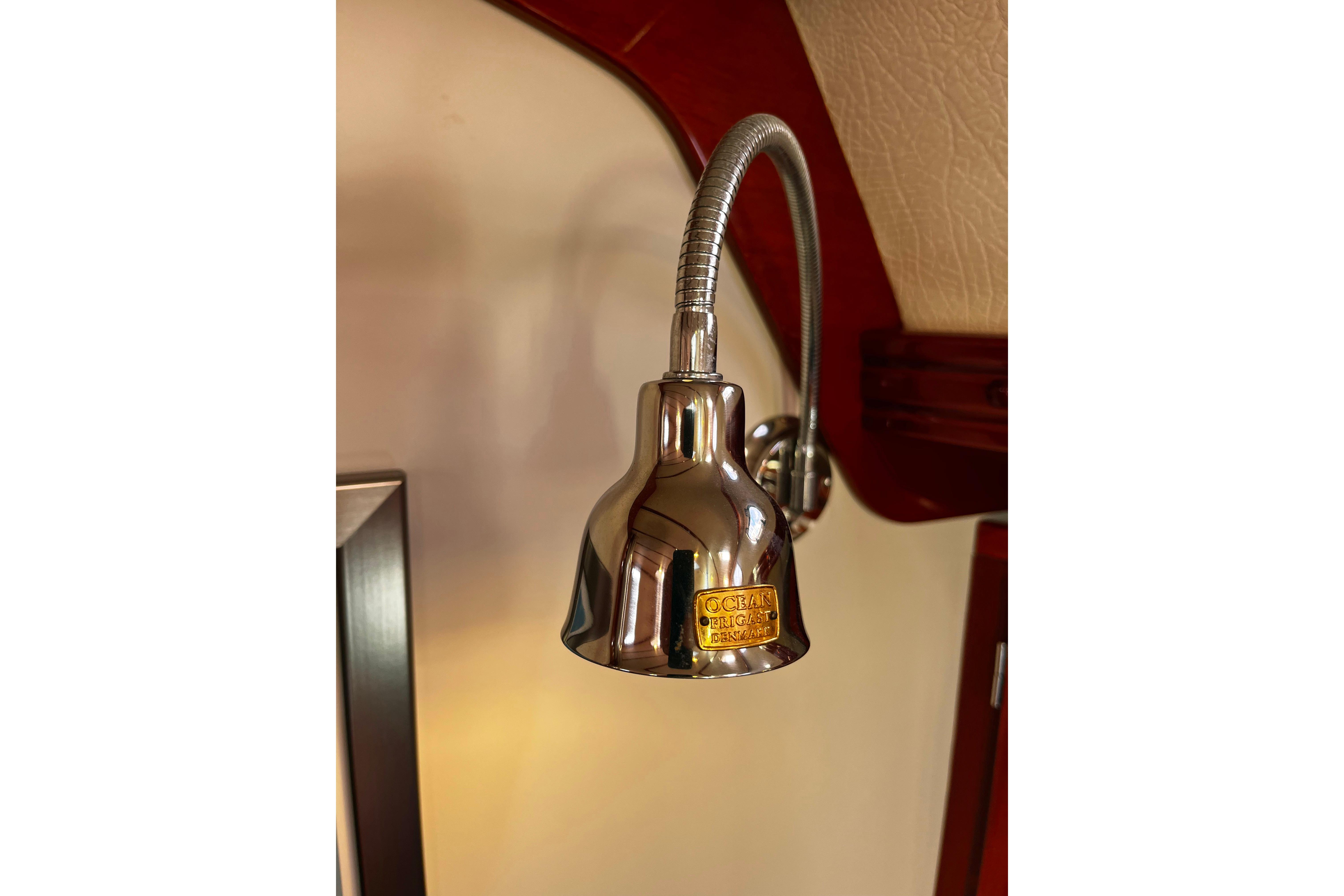 Chrome reading light fixture on a 2004 Hanse 411 yacht interior.