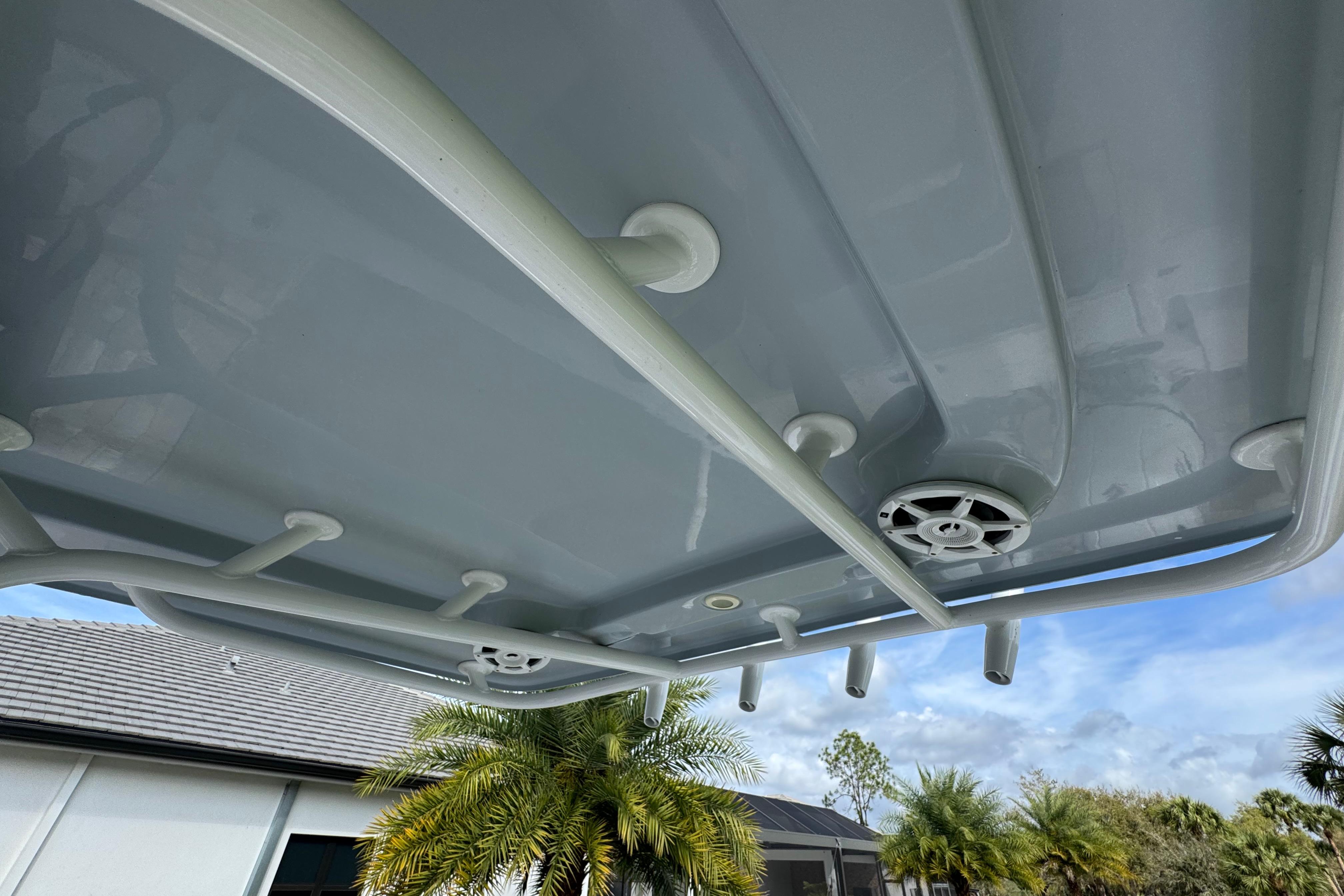 2022 Aquasport 2500 Center Console boat roof with speakers and rod holders.