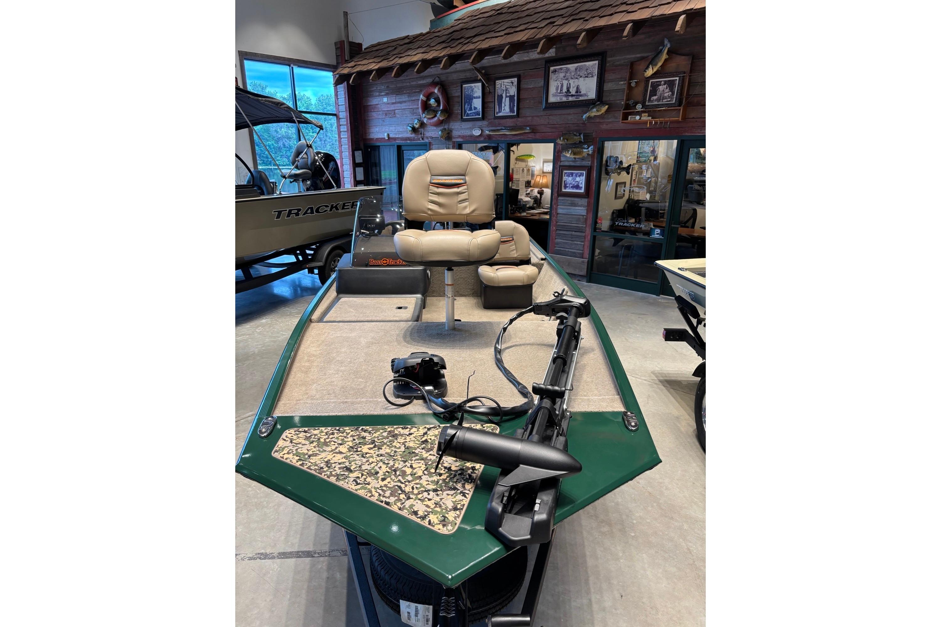 2026 Tracker Bass Tracker Classic Limited boat in showroom, featuring beige seating and trolling motor.