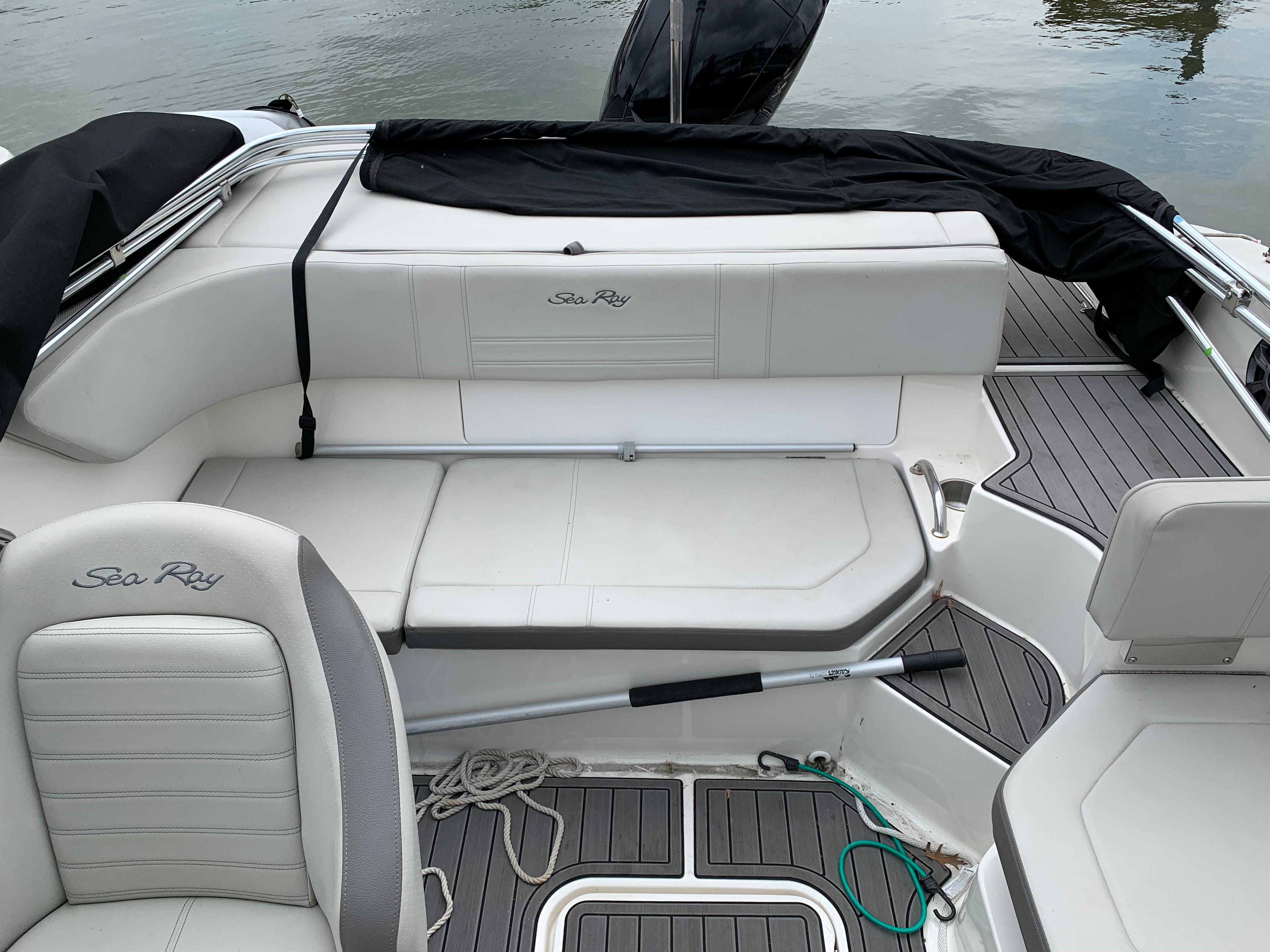 2020 Sea Ray SPX 190 Outboard boat interior with white seating and gray flooring.