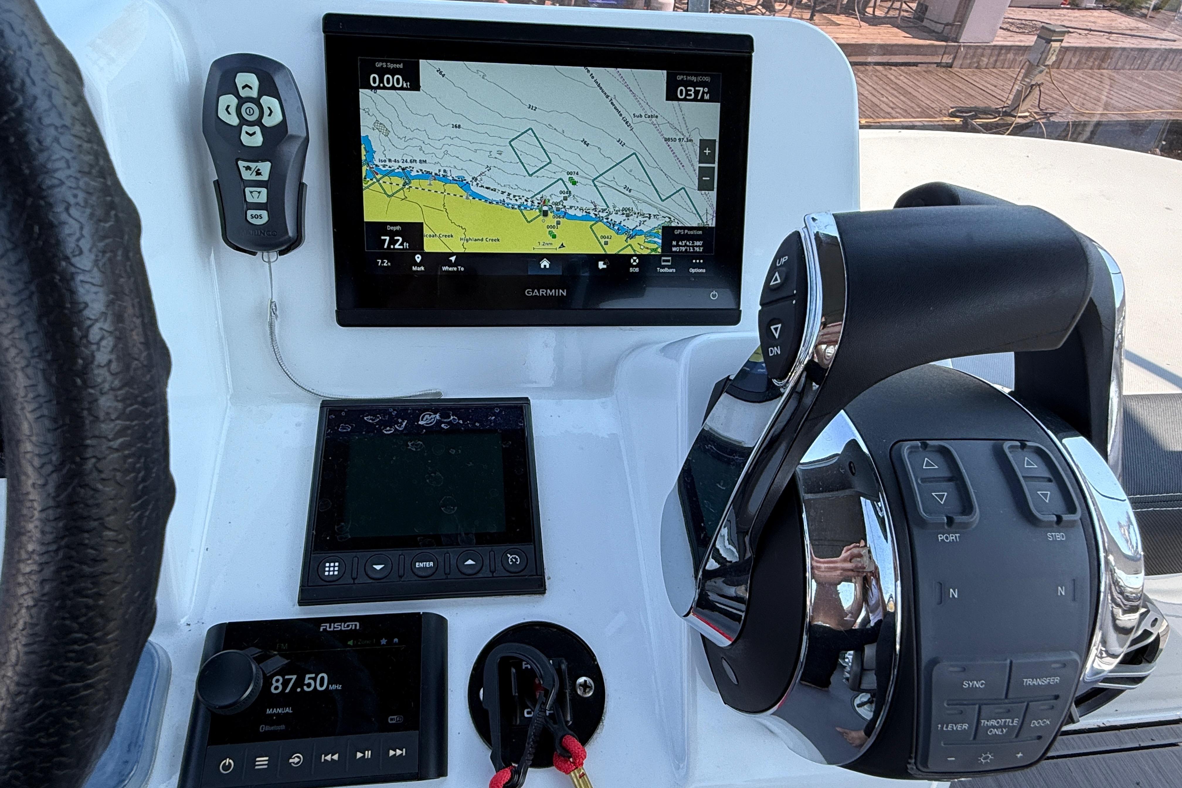 Control panel of 2022 Jeanneau NC 1095 Fly with navigation and throttle systems.