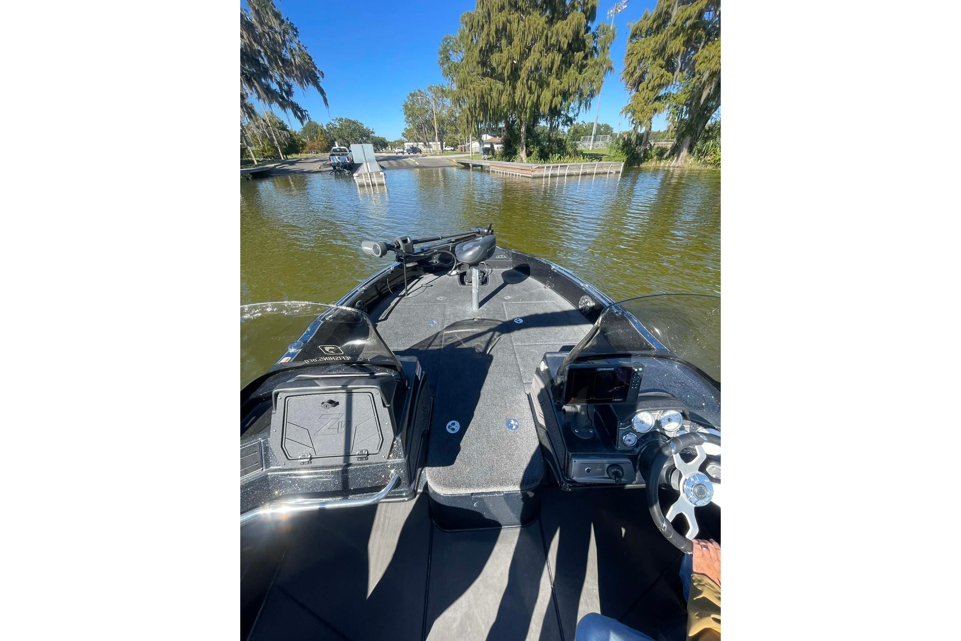 2024 Nitro ZV21 boat on a calm lake, featuring a modern dashboard and steering wheel.