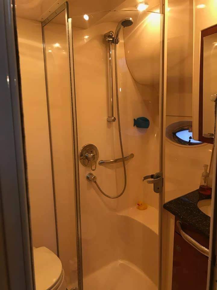 Bathroom with shower and sink on a 2004 Sea Ray Sedan Bridge.