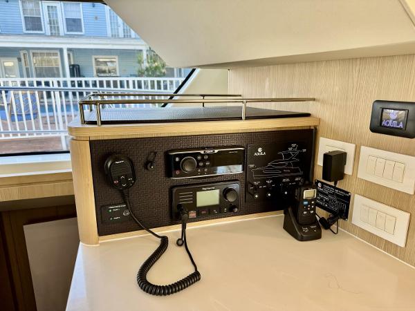 Control panel in a 2022 Aquila 44 yacht with communication equipment and switches.