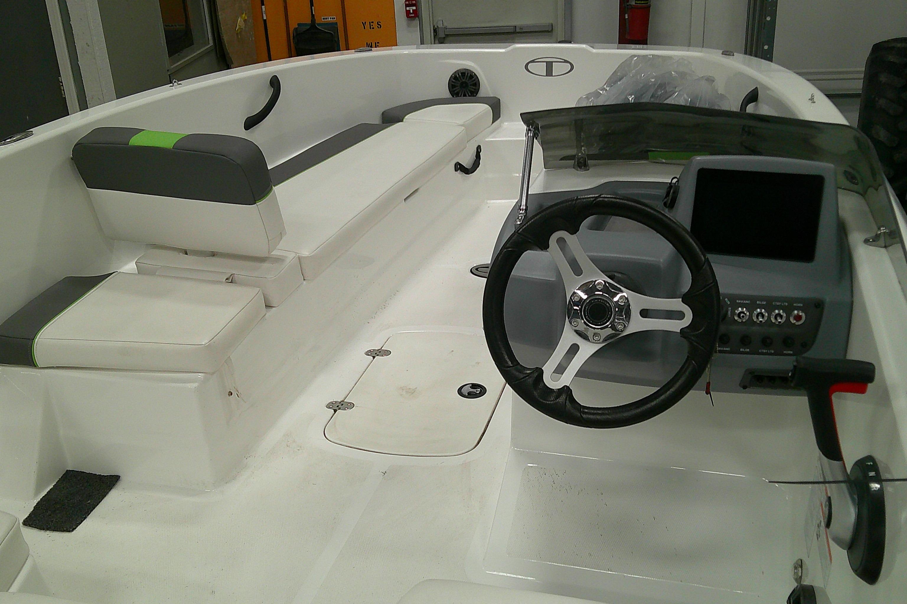 2023 Tahoe T18 boat interior with steering wheel and seating area.