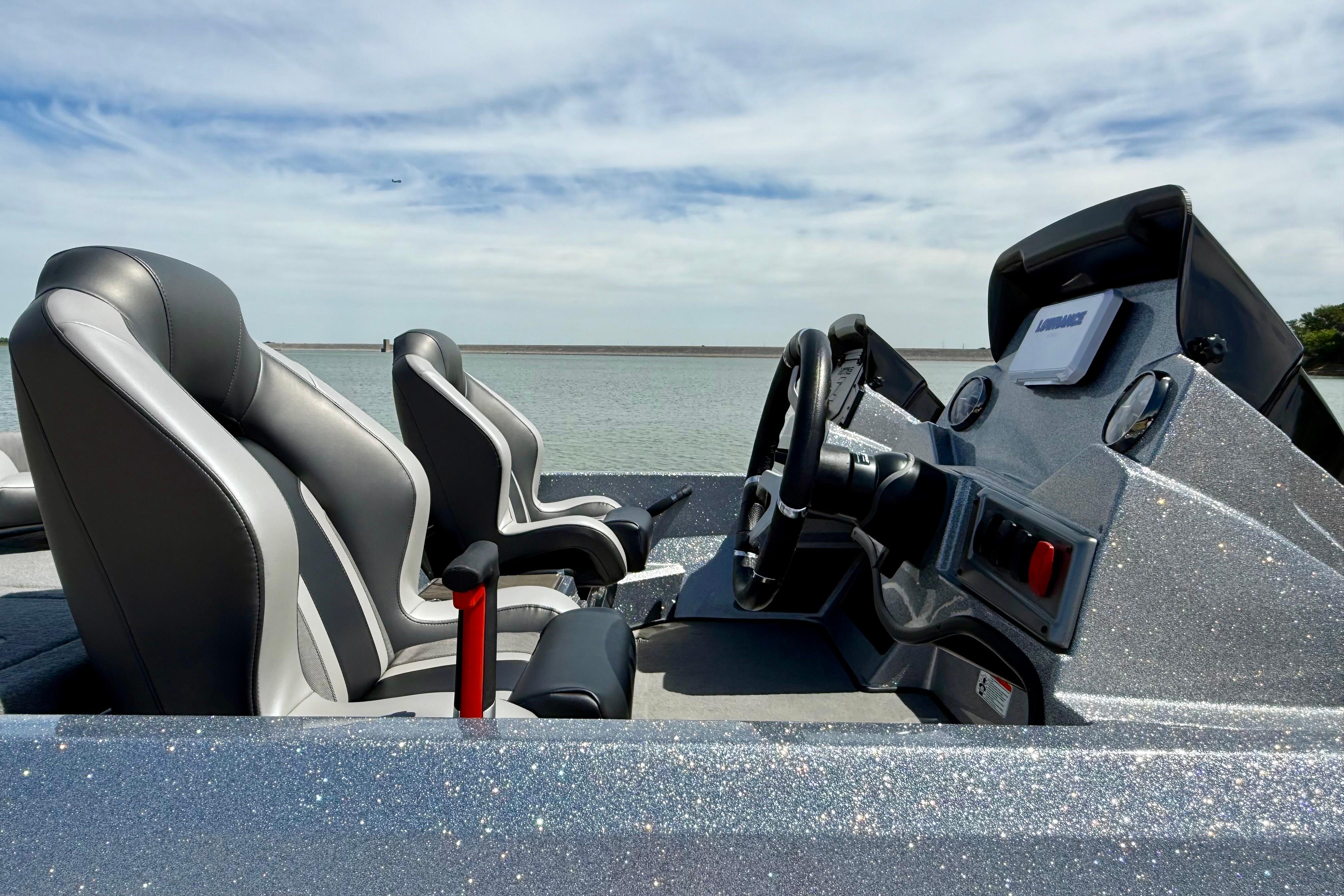 2026 Nitro Z19 XL boat interior with sleek seats and modern dashboard, overlooking serene water.