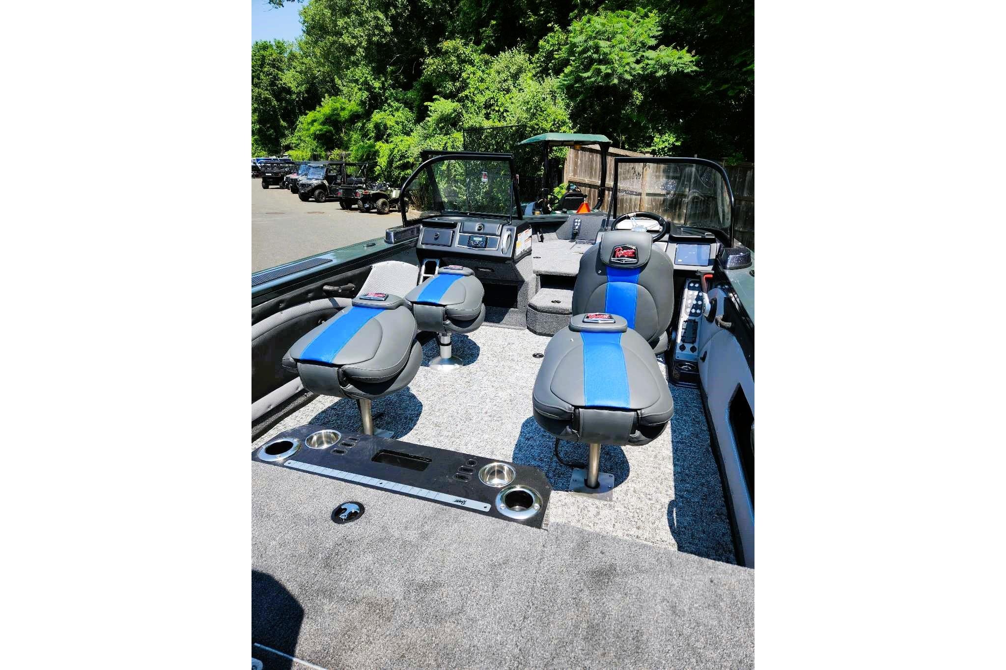 2026 Ranger VX1988 WT boat interior with blue and gray seating, surrounded by lush greenery.