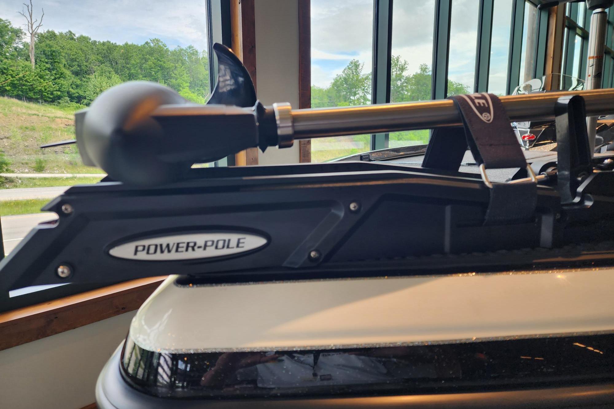 2026 Ranger Z520R boat with Power-Pole anchor system, displayed indoors with scenic window view.