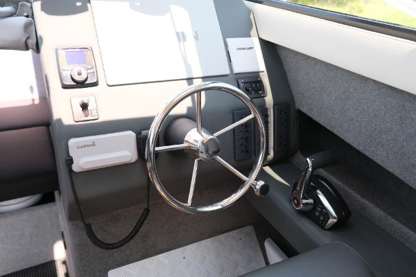 2023 Makaira Gen3 800 boat helm with steering wheel and control panel.
